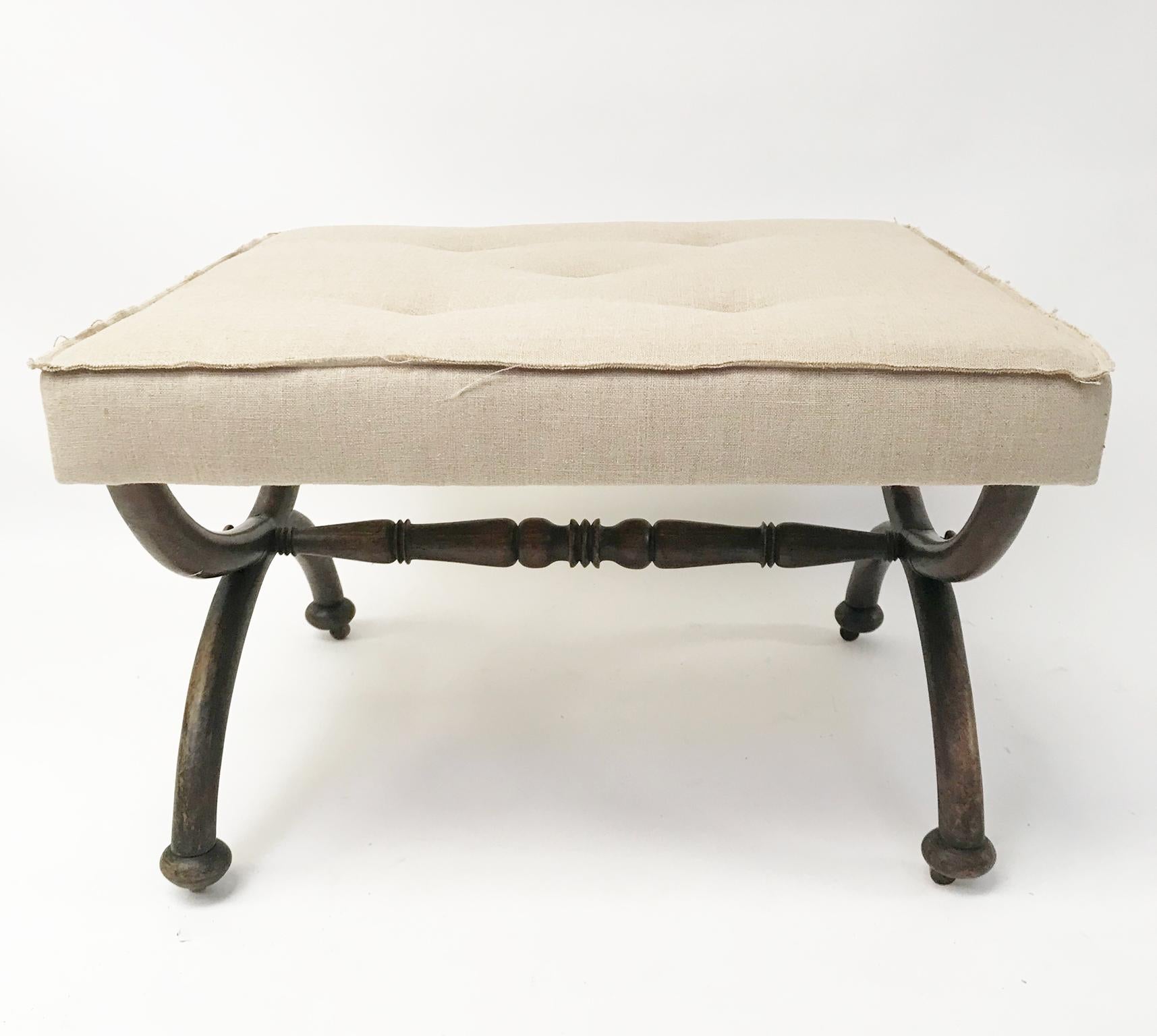 A large late Regency X-framed English stool, circa 1840.
The large squared top upholstered in linen, x-frame, with a turned rosewood central stretcher, hidden ceramic coasters under bun terminal feet. 
Upholstered stylishly with a raw edge in a