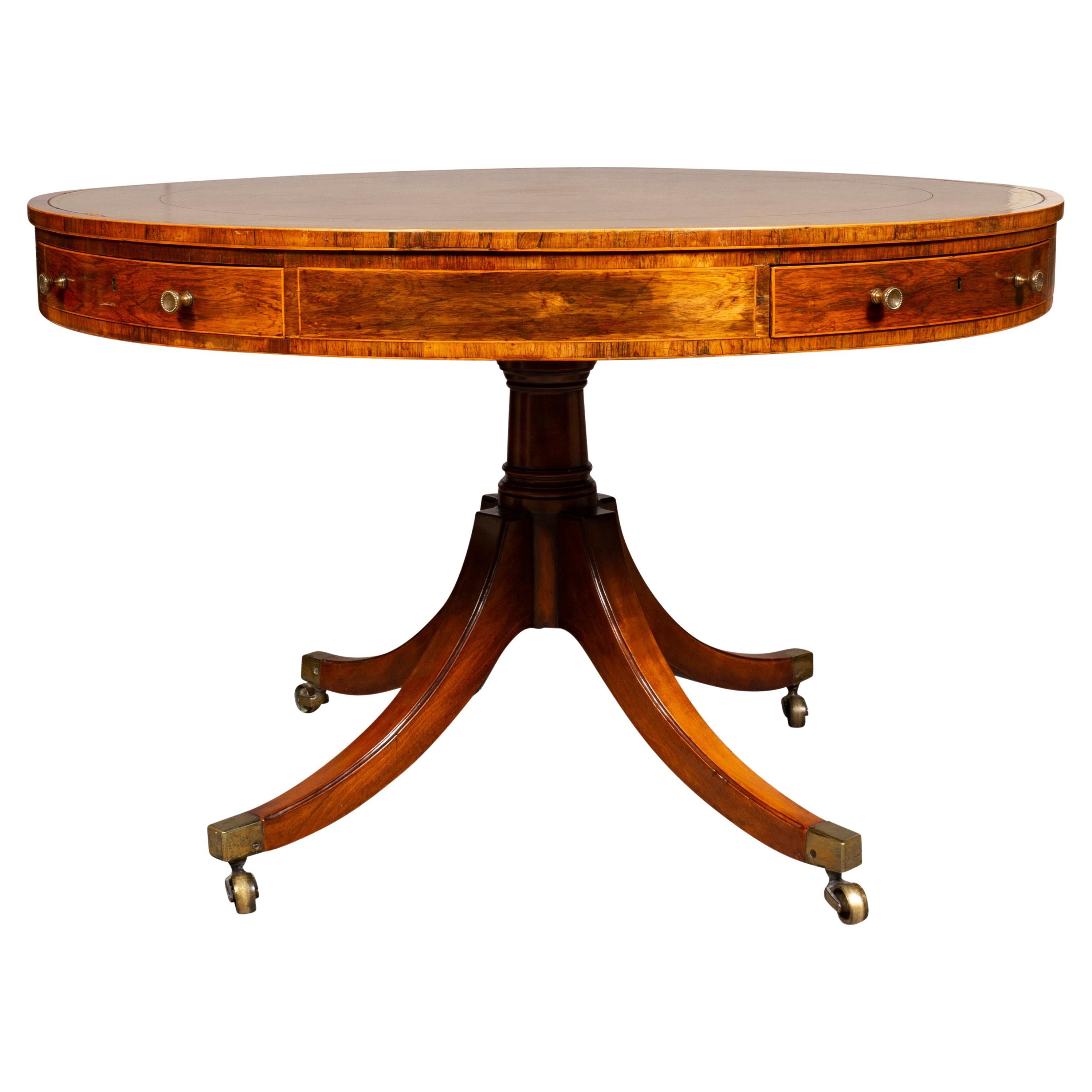 Circular top with inset brown leather within a cross banded edge, conforming frieze with alternating drawers with brass knobs. Raise on a turned support with four saber legs with casters.
Provenance; Supplied to King George IV [1762-1830] when