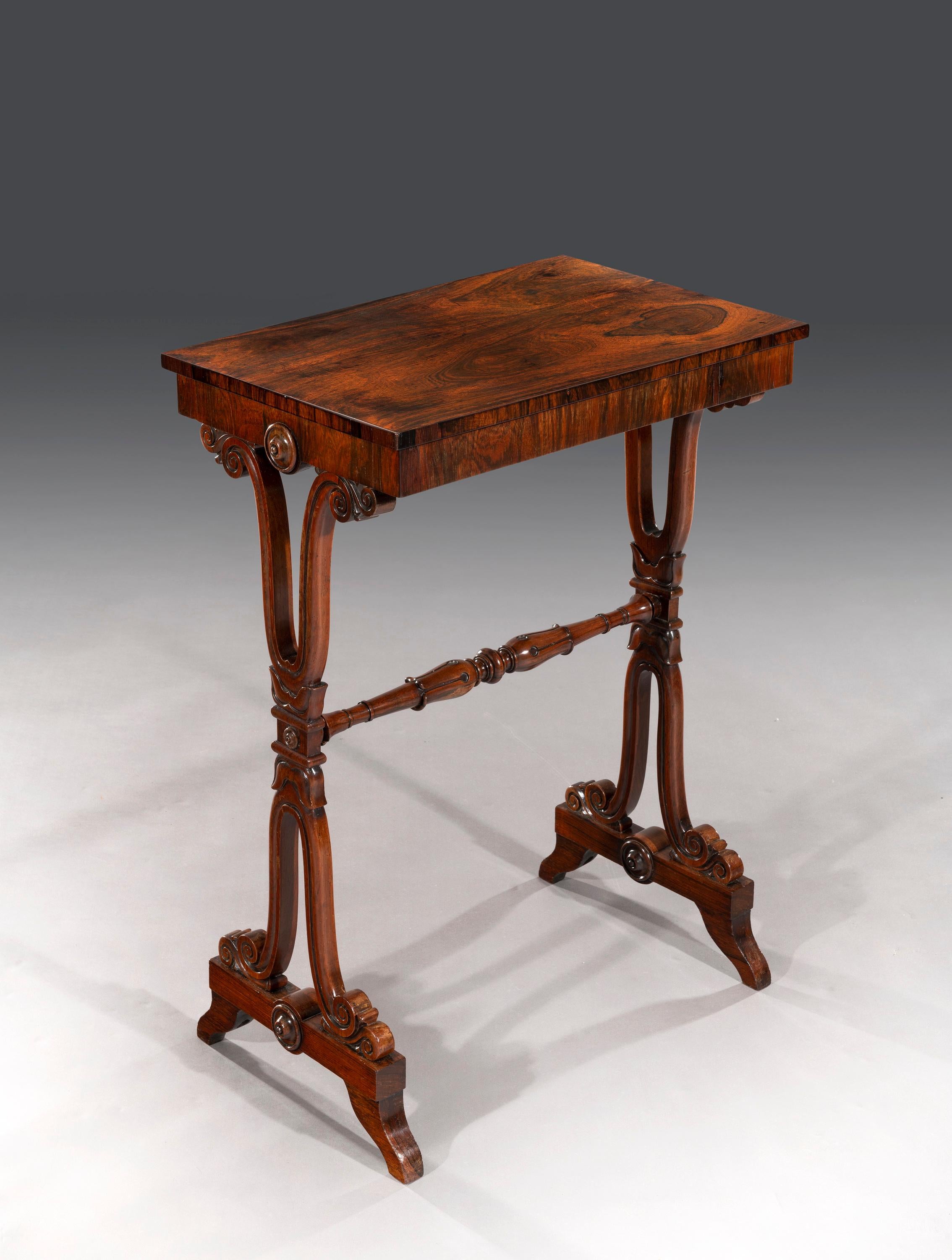 A fine diminutive rectangular figured walnut side table with highly decorative carved end supports that stand on plinths and shaped toes. 


George Smith's 