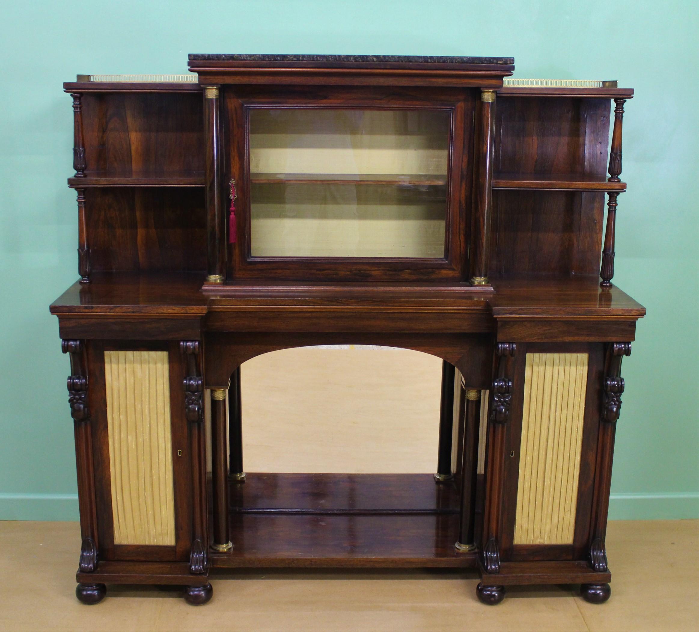A splendid late Regency period rosewood chiffonier or side cabinet. Of excellent construction in solid rosewood with attractive rosewood veneers onto a mahogany carcas. The top section with a single glazed door (lockable with key supplied) which