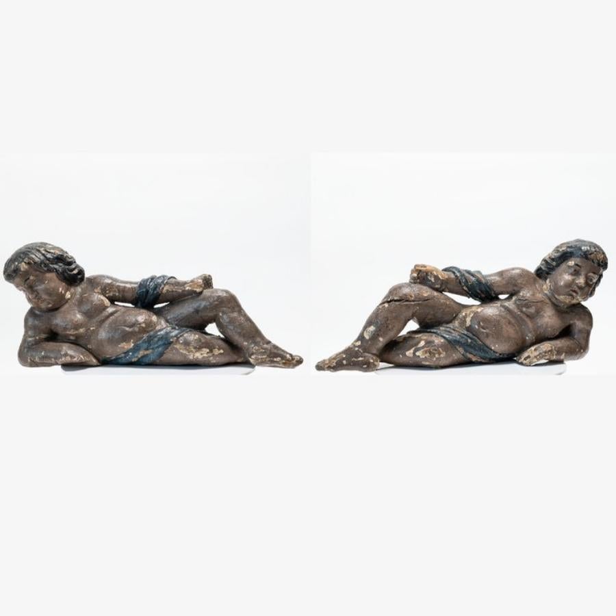 This extraordinary pair of Late Renaissance/Early Baroque Genovese Italian wood cherubs is a testament to the exceptional craftsmanship and artistic finesse of the era. Carved from exquisite wood, these cherubs embody the delicate beauty and