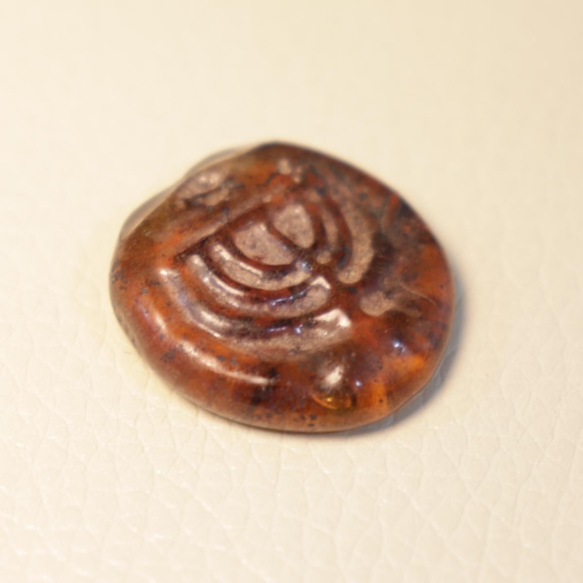 Israeli Late Roman/Byzantine Jewish Amber Color Glass Amulet with Menorah For Sale