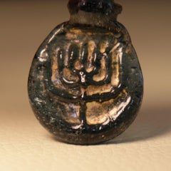 Late Roman/Byzantine Jewish Blue Glass Amulet with Menorah