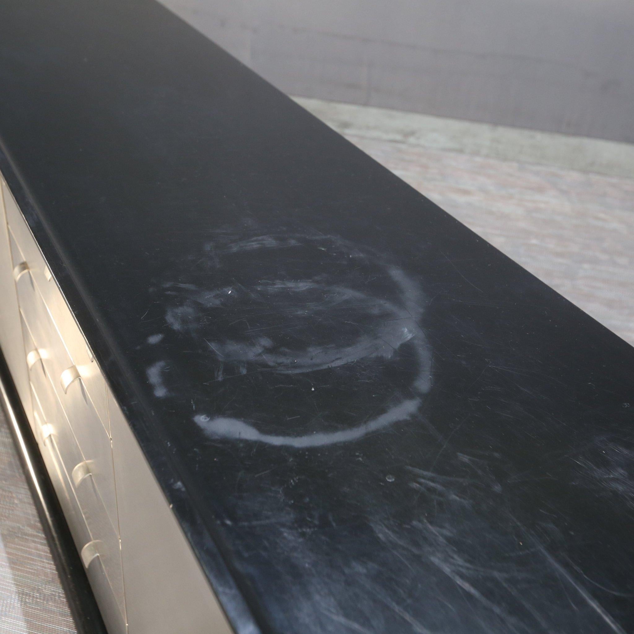 Introduce a touch of retro elegance to your living space with our stunning late sixties black and platinum sideboard. Crafted with meticulous attention to detail, this piece exudes sophistication and style. The sleek black exterior is beautifully