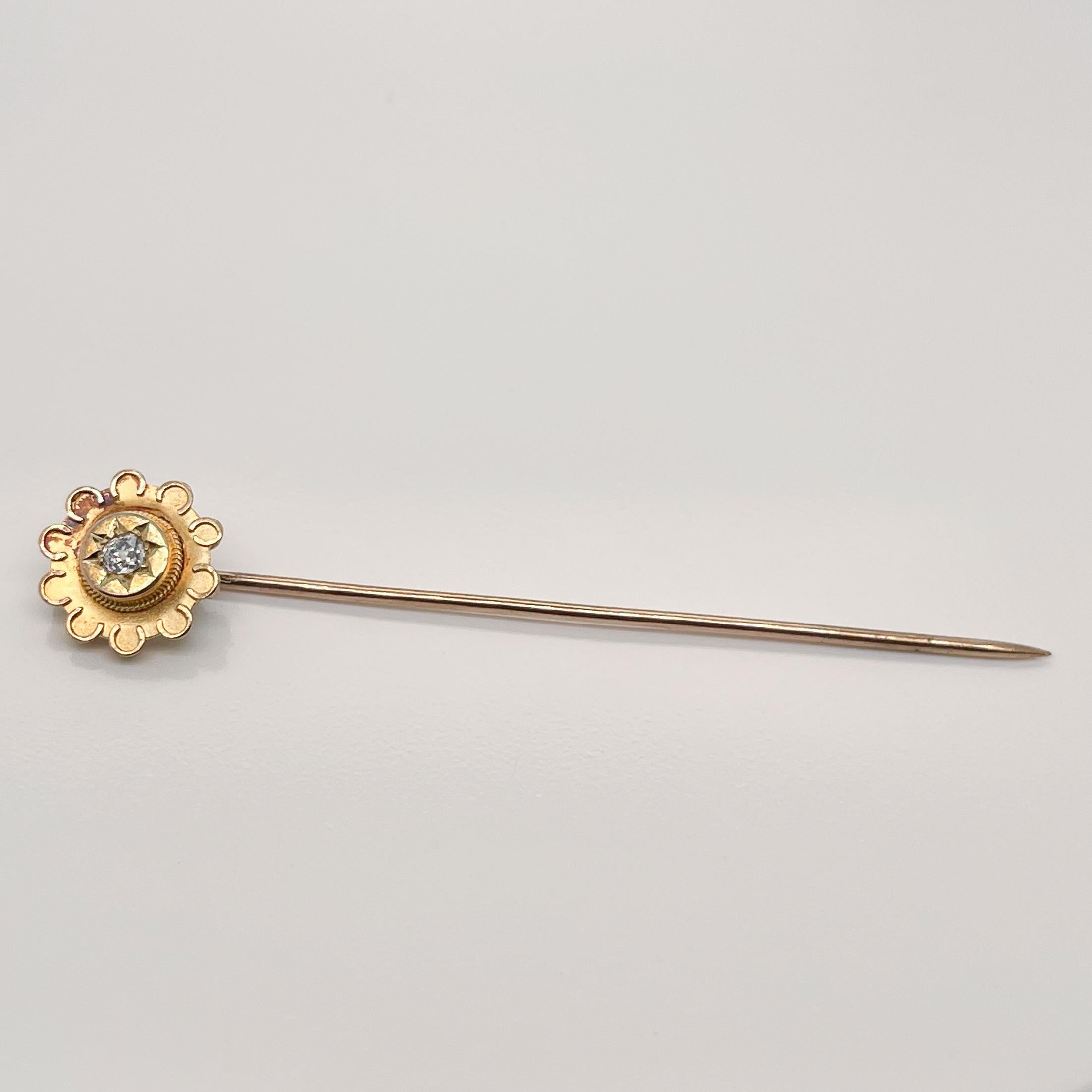 A very fine 14k gold and diamond stick pin.

Converted from a Late Victorian larger piece of jewelry.

With a round brilliant cut diamond pave set in center of a 14k gold flower shaped top.

Simply a great stickpin!

Date:
19th Century

Overall