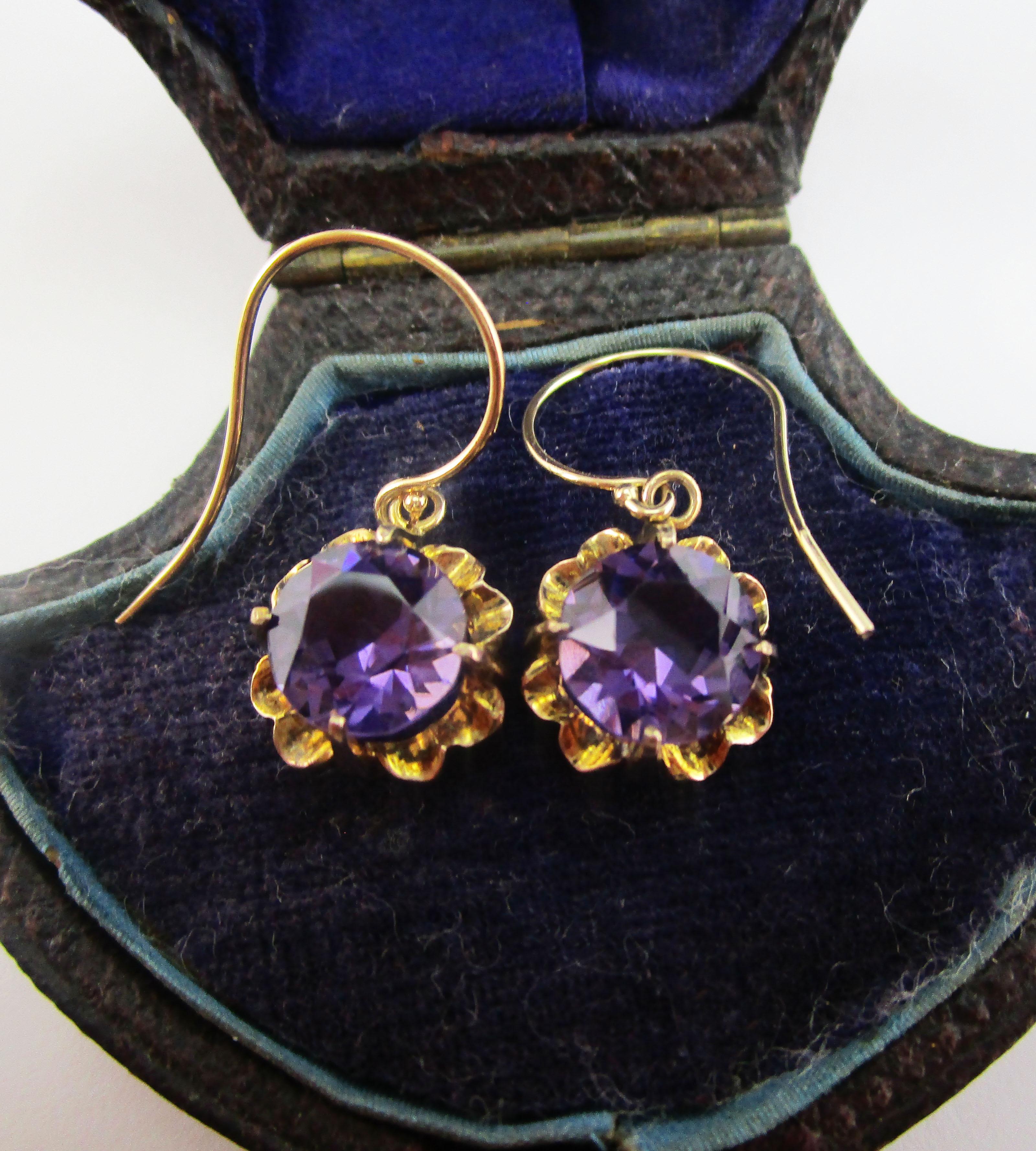 This is a gorgeous pair of Victorian dangle earrings in delicate rose gold with beautiful royal purple amethyst centers. The earrings have a unique four prong setting in an arching floral earring that is completely articulated. The complementary