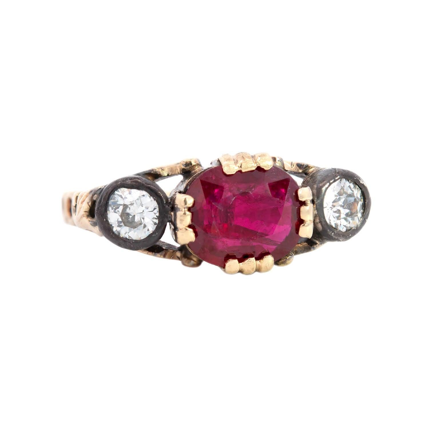 A beautiful gemstone ring from the Late Victorian (ca1900) era! This gorgeous piece is crafted in 14k yellow gold and sterling silver and features a beautiful ruby in 4 triple prongs between the sparkling diamonds. Set in the center is a single