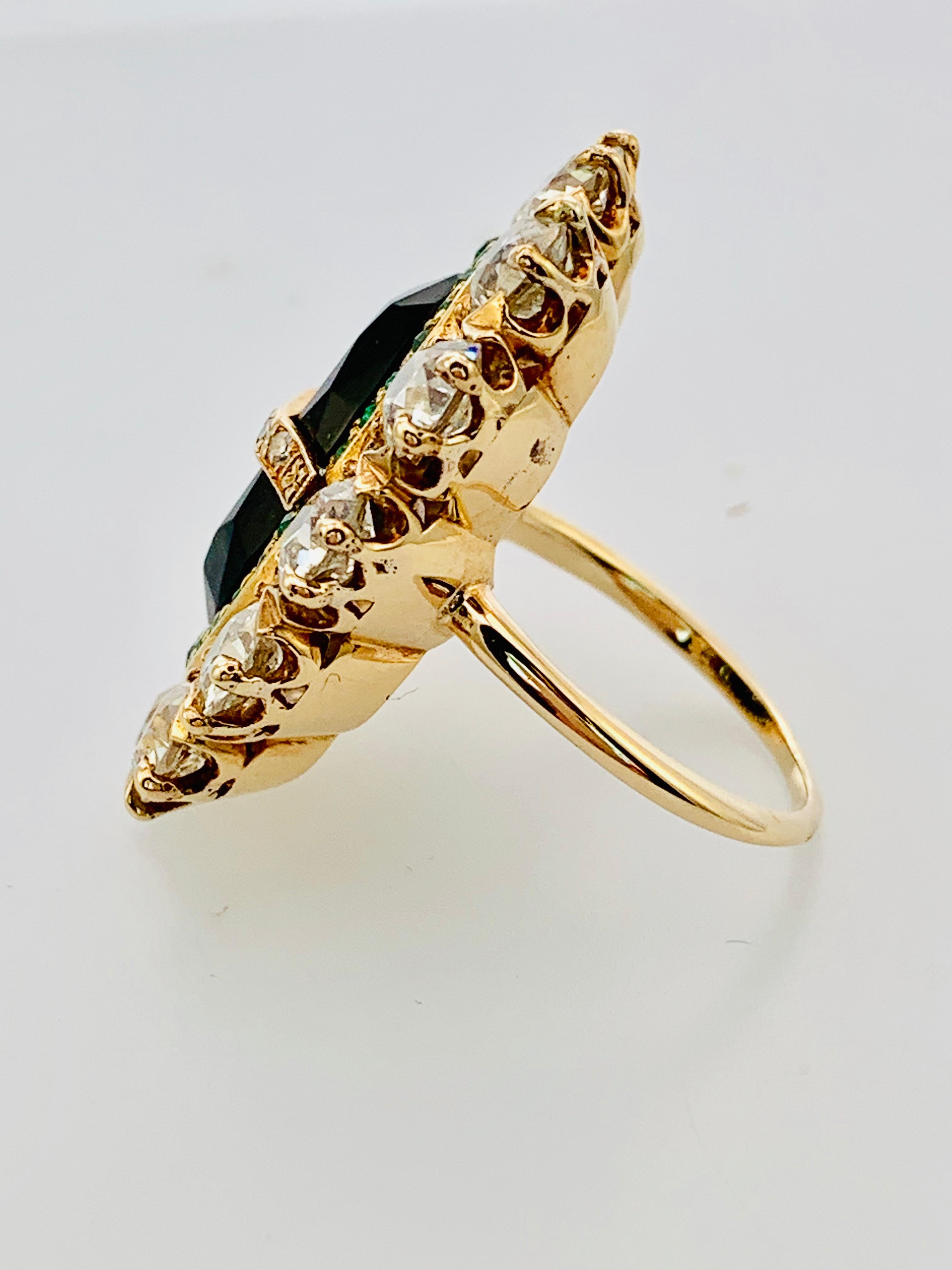 Gorgeous Late Victorian Era Ring!  Made in 14K yellow Gold, this piece features stunning 16 by 9mm Oval Onyx at the center that is surrounded by a rim of 28 round emeralds! The onyx is also crossed by a strip of six small diamonds. Then there is a