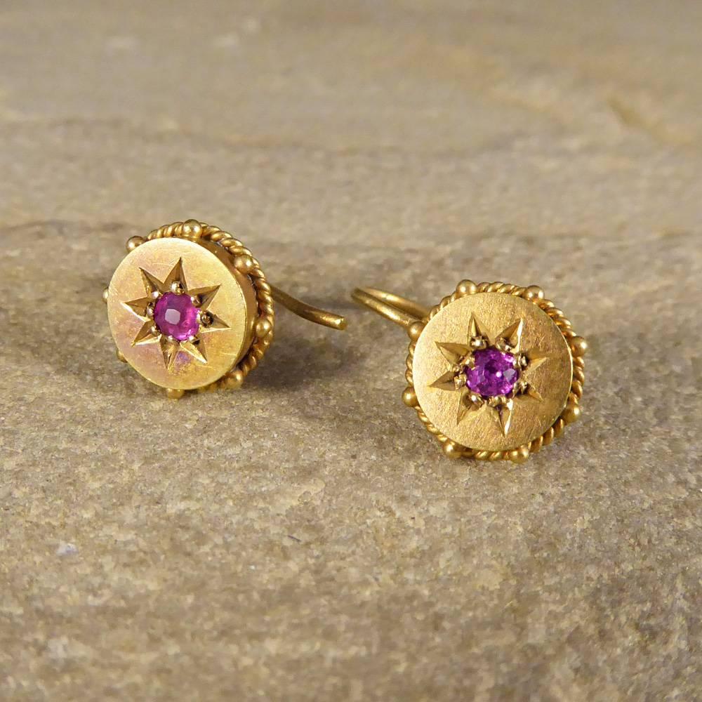 Beautiful Late Victorian Earrings created from 15ct Yellow Gold, showing a slight Etruscan motif edge, commonly used during this period. Dainty and understated yet such a quality pair of earrings with two single Rubies, embedded into star settings