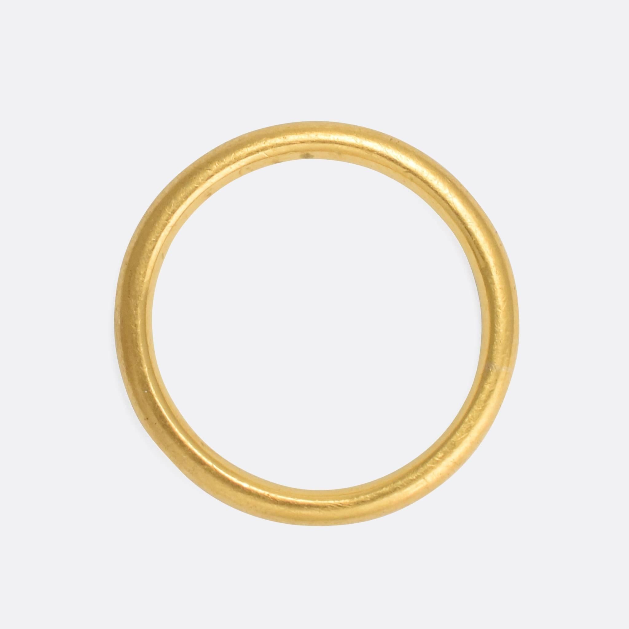 A fine quality antique wedding band, modelled in 18 karat yellow gold. It dates to the late 19th Century, crafted by hand with a round 