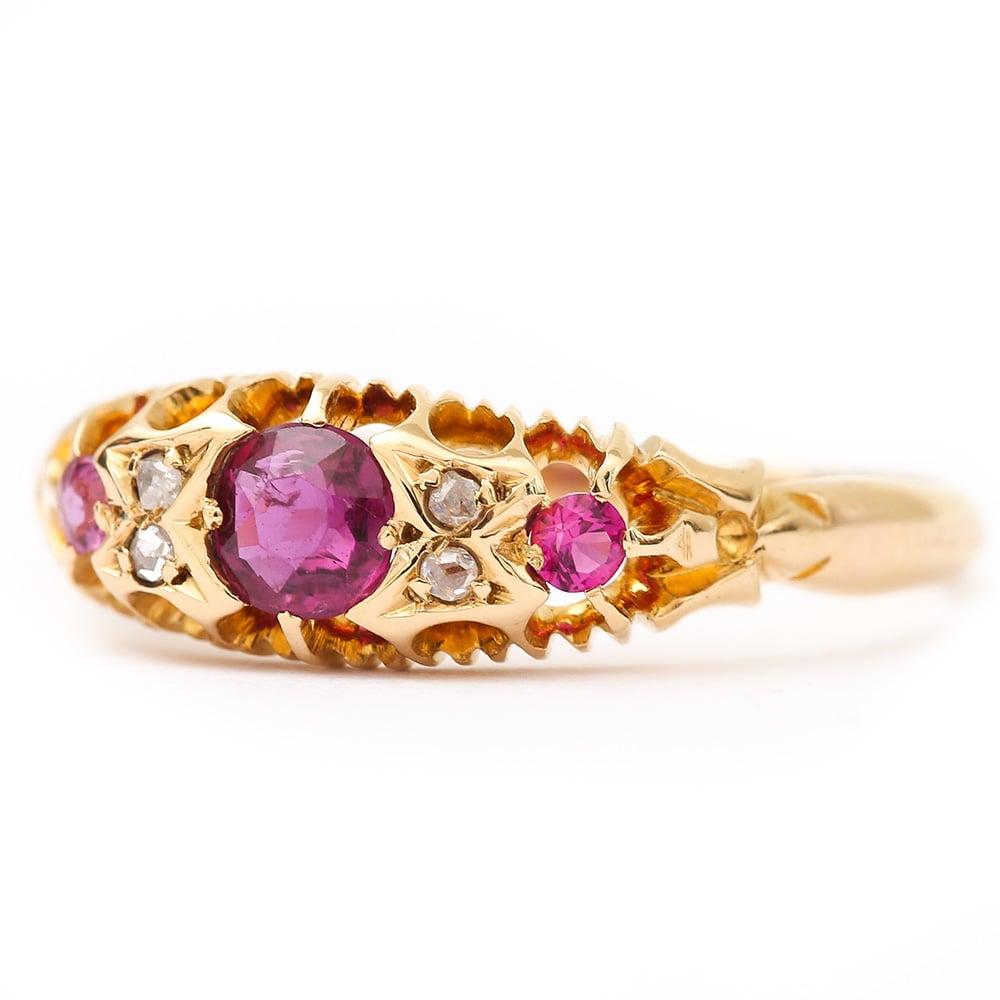 A late Victorian 18 karat yellow gold ruby and diamond seven stone gypsy ring that was hallmarked in 1897. It is such a pretty example displaying such a good colour for the rubies with deep purplish reds. The claw set stones in this traditional