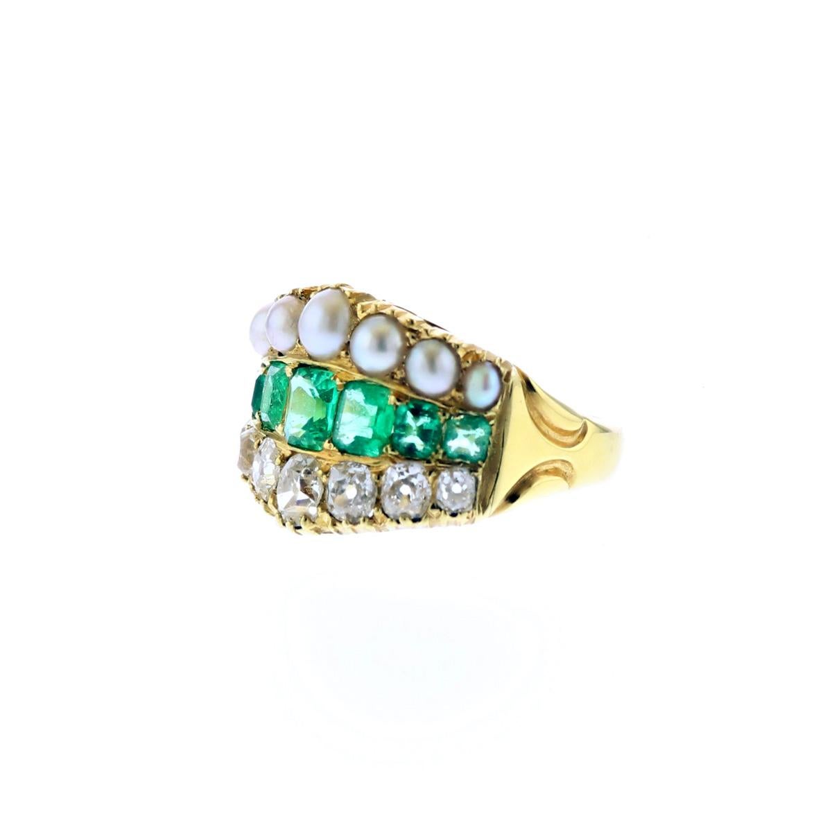 Late Victorian 18K yellow gold wide tapered half-hoop ring, set with a row of diamonds, a row of emeralds, and a row of split pearls. Circa 1885.  Ring contains seven Old Mine-cut diamonds that total 1.24 carats, seven step-cut, slightly blueish