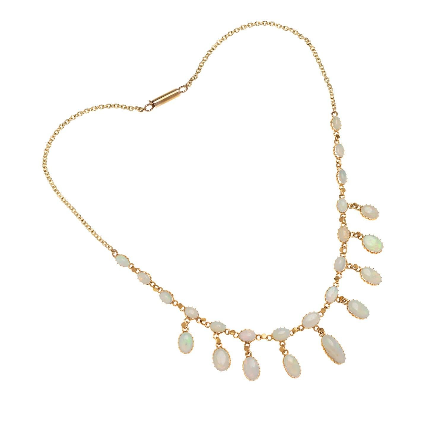 A stunning necklace from the Late Victorian (ca1900s) era! Crafted in 18kt yellow gold, this gorgeous riviere festoon necklace features 24 incredible Australian Opal cabochons. The opals display an incredible range of rainbow hues, flashing with