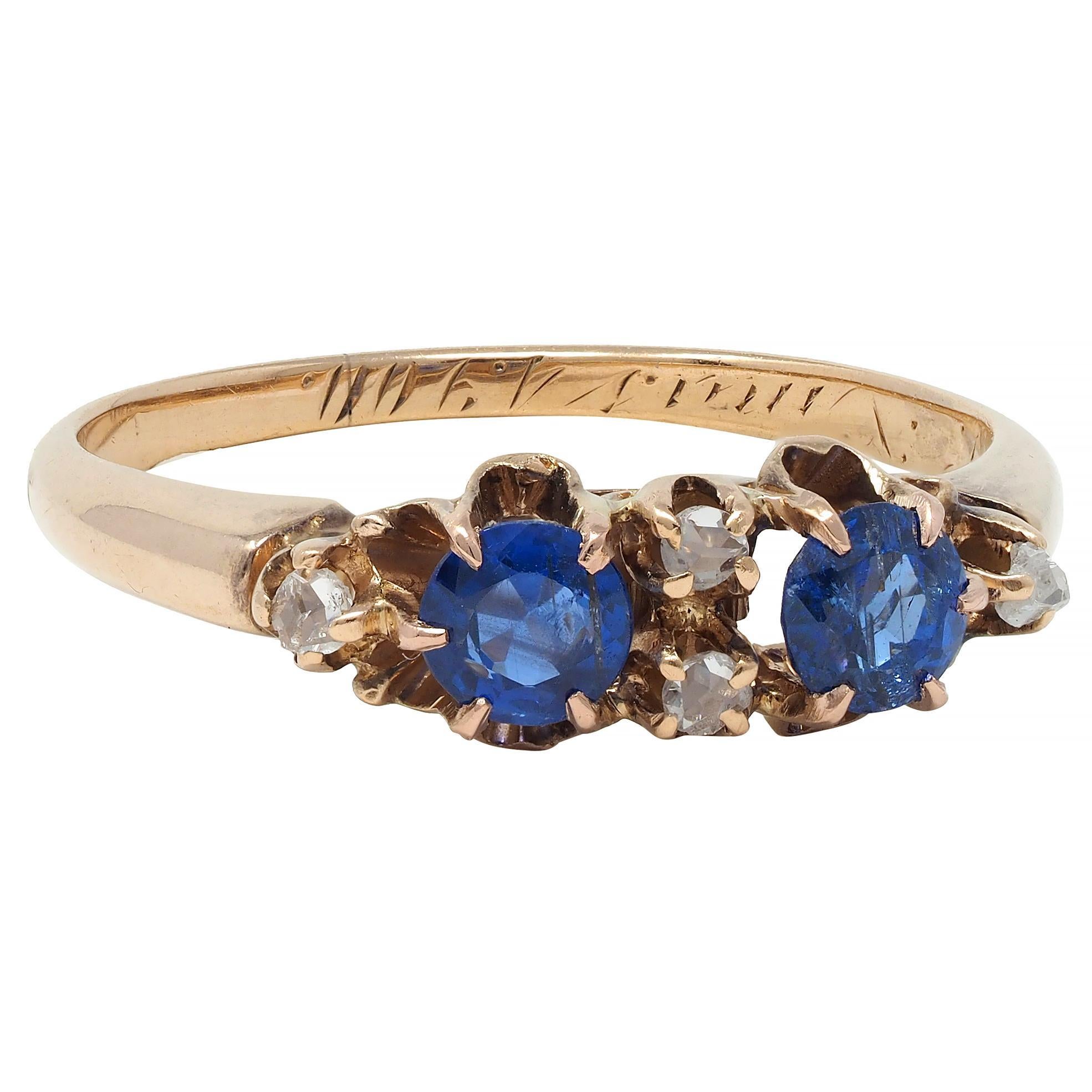 Featuring two round cut sapphires weighing approximately 0.40 carat total 
Transparent medium blue in color - alternating with rose cut diamonds
Weighing approximately 0.04 carat total - eye clean and bright
All set east to west with belcher style