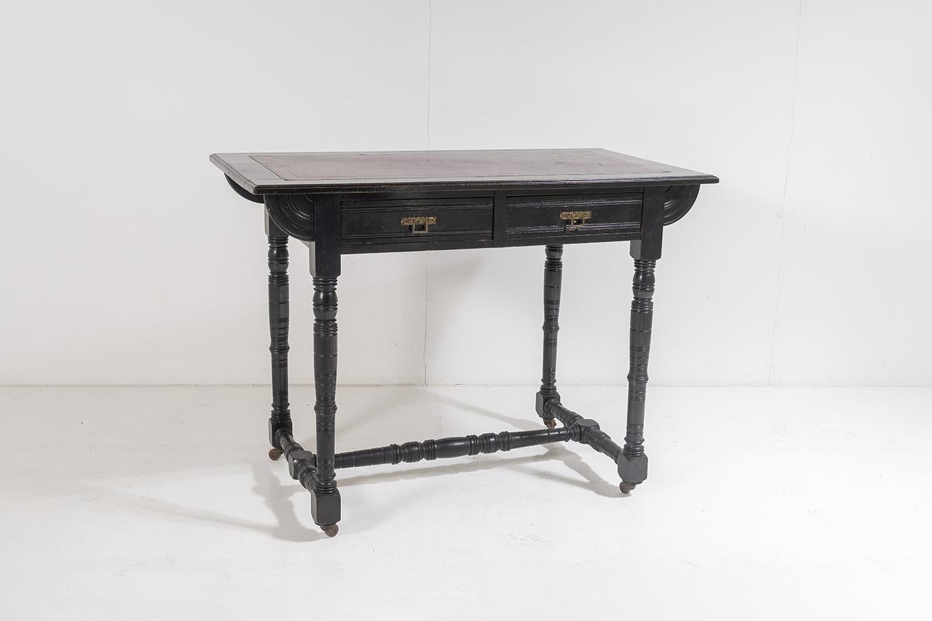 A superb little aesthetic movement writing desk is black mahogany ebonised finish with it original red leather inset top.

This piece contains so many wonderful detailing, the inset leather top features a gilt Greek Key border followed by a