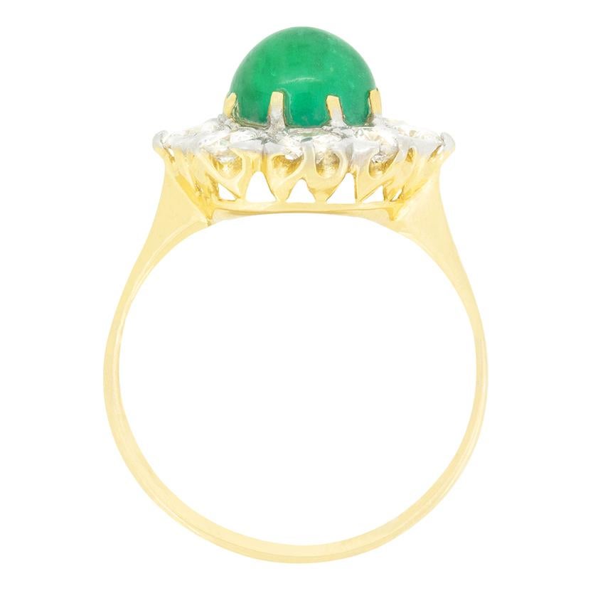 Cette magnifique bague en forme de grappe date de la fin de l'ère victorienne et est centrée sur une magnifique émeraude d'un vert vif. L'émeraude de 2,40 carats est une pierre taillée en cabochon, sertie dans des griffes en or jaune 18 carats.