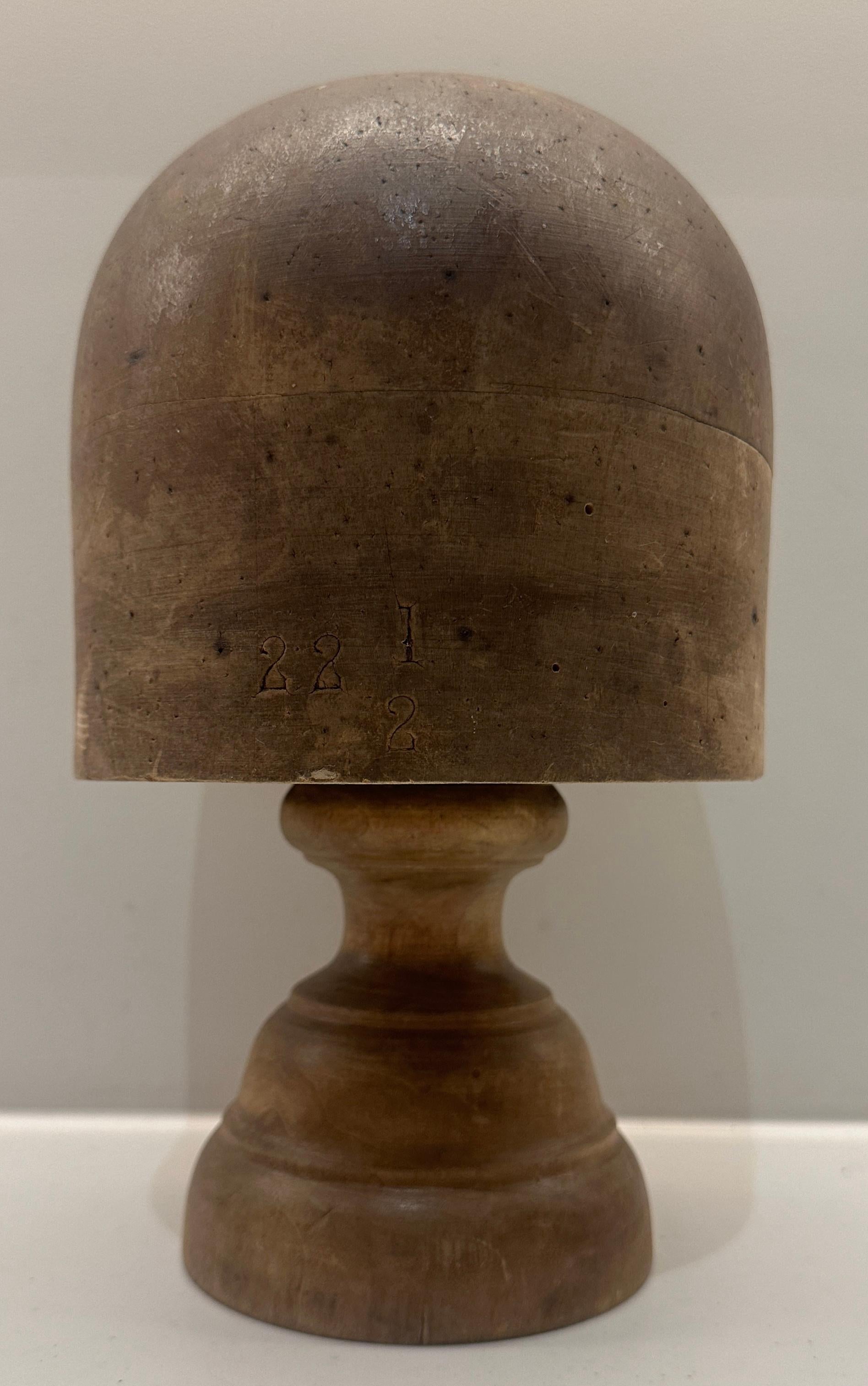 Early 20th Century Victorian solid beech millinery block stand which has been varnished which has worn away in places to reveal its unfinished natural condition.  The numerous pin marks from years of making hats add to its character and provenance.