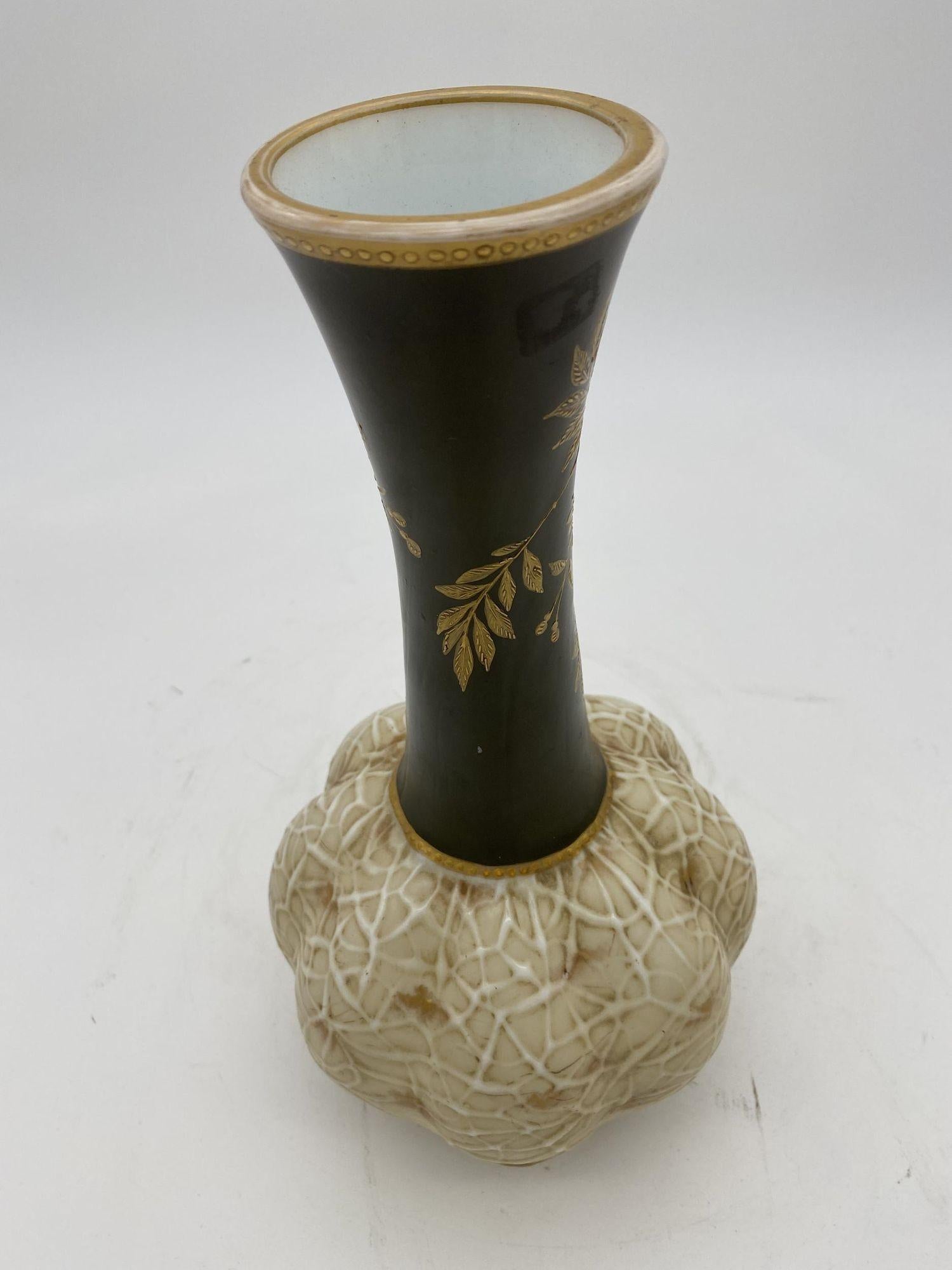 Late Victorian bohemian opal harrach uranium art glass vase featuring plomb bottom with vein bottom with black painted neck decorated with gold leaf floral neck.


Czechoslovakia, 1890