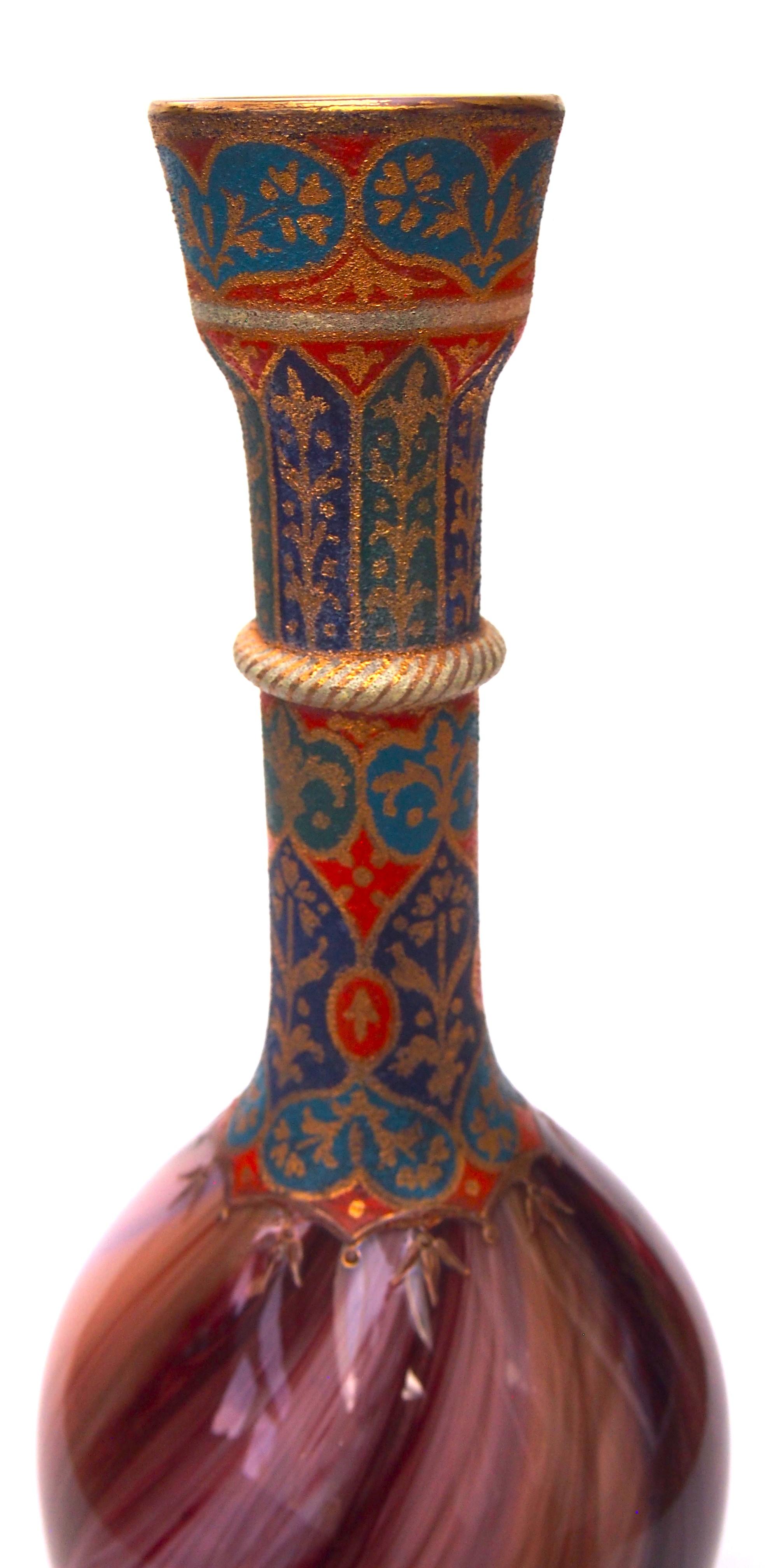 A dramatic tall early Loetz vase. Very early and imposing Loetz enamelled Onyx pattern vase, brown and red on a pink base with blue stripes and classic Islamic style enamelling down the collar and repeated around the base. Probably made for the
