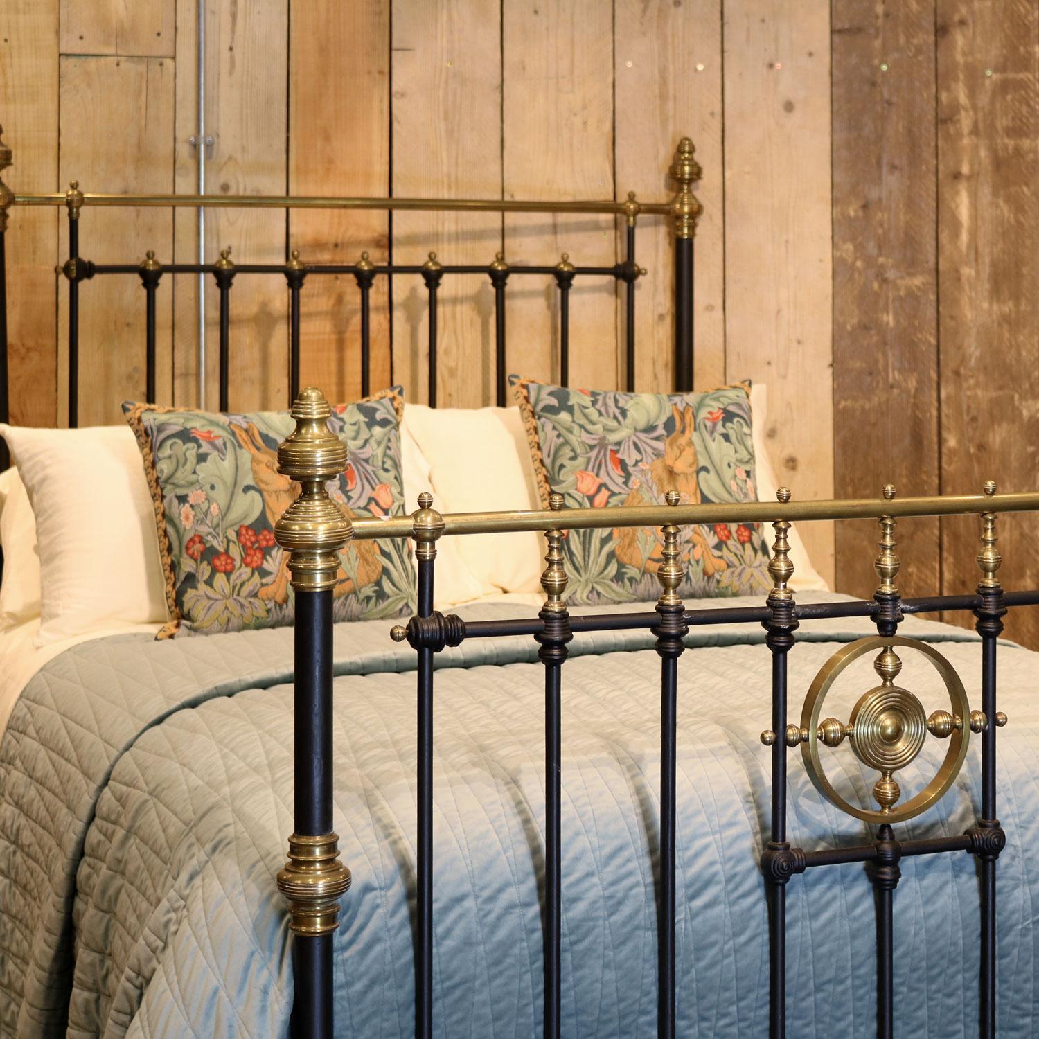 Late Victorian brass and cast iron bedstead, finished in black with straight brass top rail and striking brass centrepiece in the foot board. This bed also has some lovely mouldings with brass detailing throughout. 

This bed accepts a double size