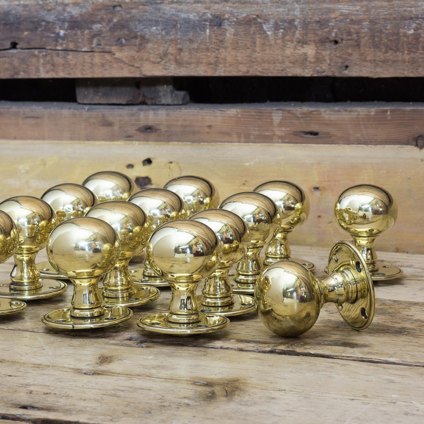 Late Victorian spherical brass door knobs on circular backplates. Four pairs available.