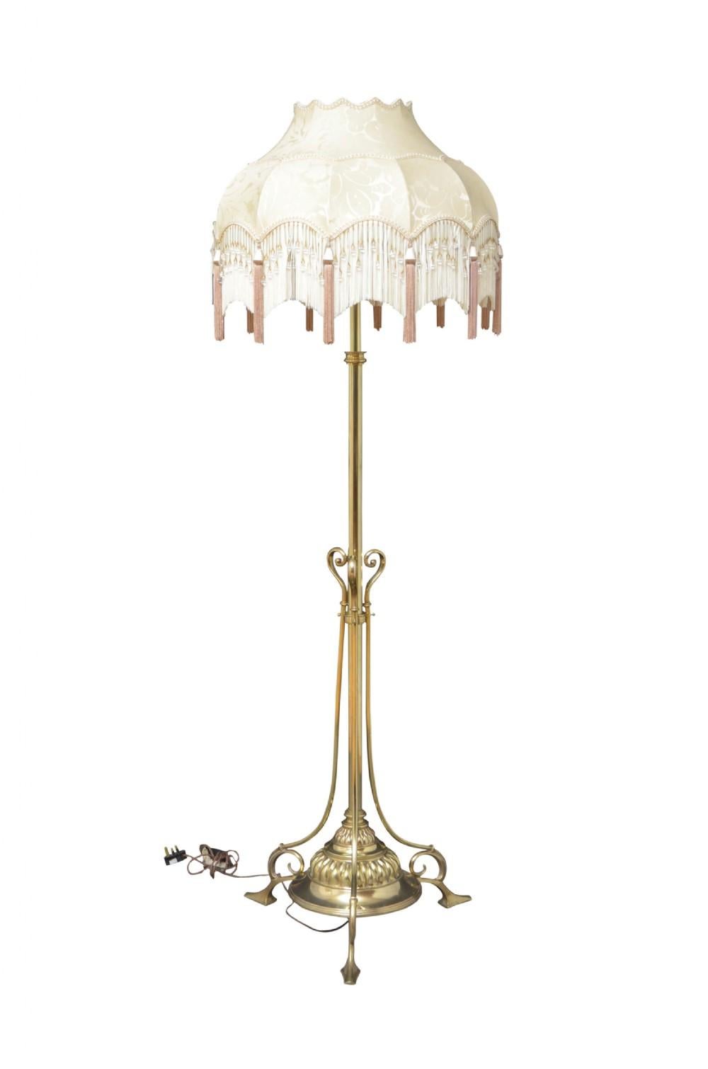 Late Victorian / Edwardian standard lamp, having adjustable column terminating in circular fluted base with three scroll supports and pad feet. This antique lamp has been cleaned, polished and professionally rewired. All in excellent home ready