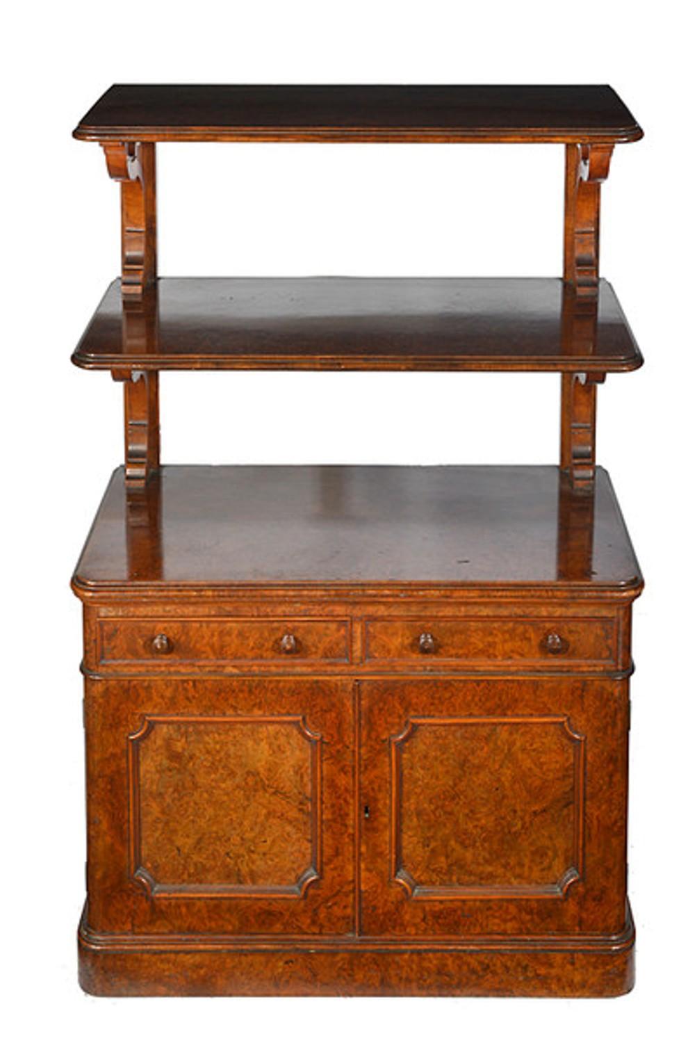 A late Victorian burr walnut cabinet with a pair of useful raised stands to the top.
The base with two drawers and a pair of panel doors below which open to reveal a lead lined celleret to one side and a single shelf to the other.
The whole