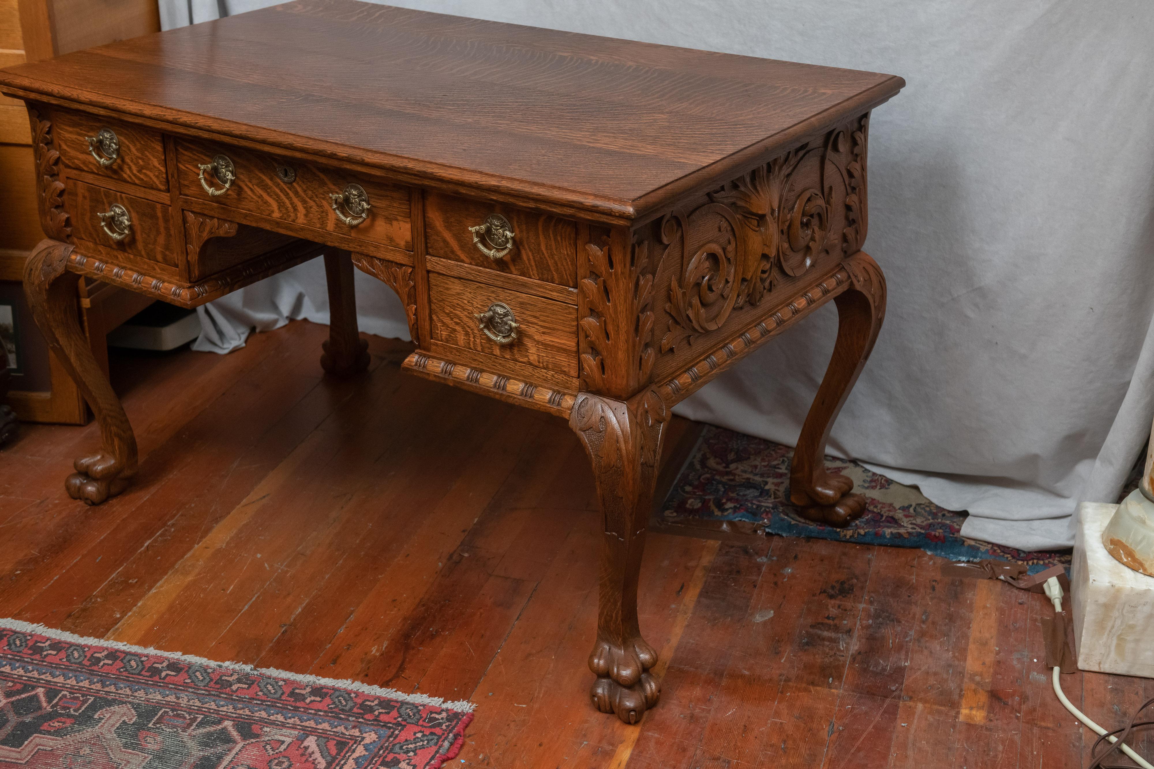 Late Victorian Carved American Tiger Oak Partner's Desk. It's hard to imagine a better example of this style desk. The carving is crisp, the oak is the best cut, the brass handles are special, and even the drawer construction is top shelf. The