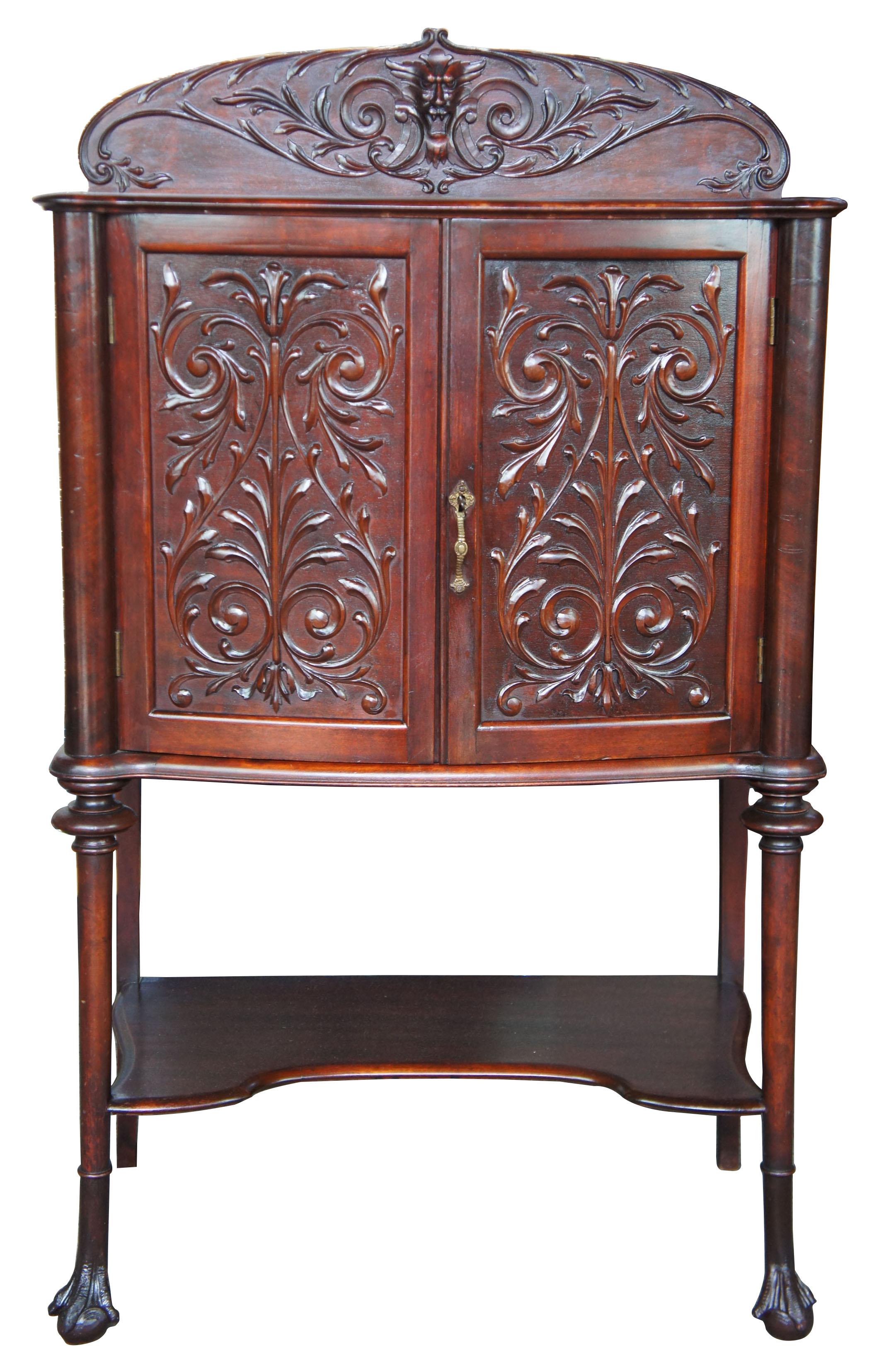 Late Victorian carved mahogany music cabinet ball and claw foot backsplash dry bar

Late Victorian mahogany music cabinet. Empire inspired with curved supports leading to ball and claw feet. Includes carved doors and a figural backsplash with a