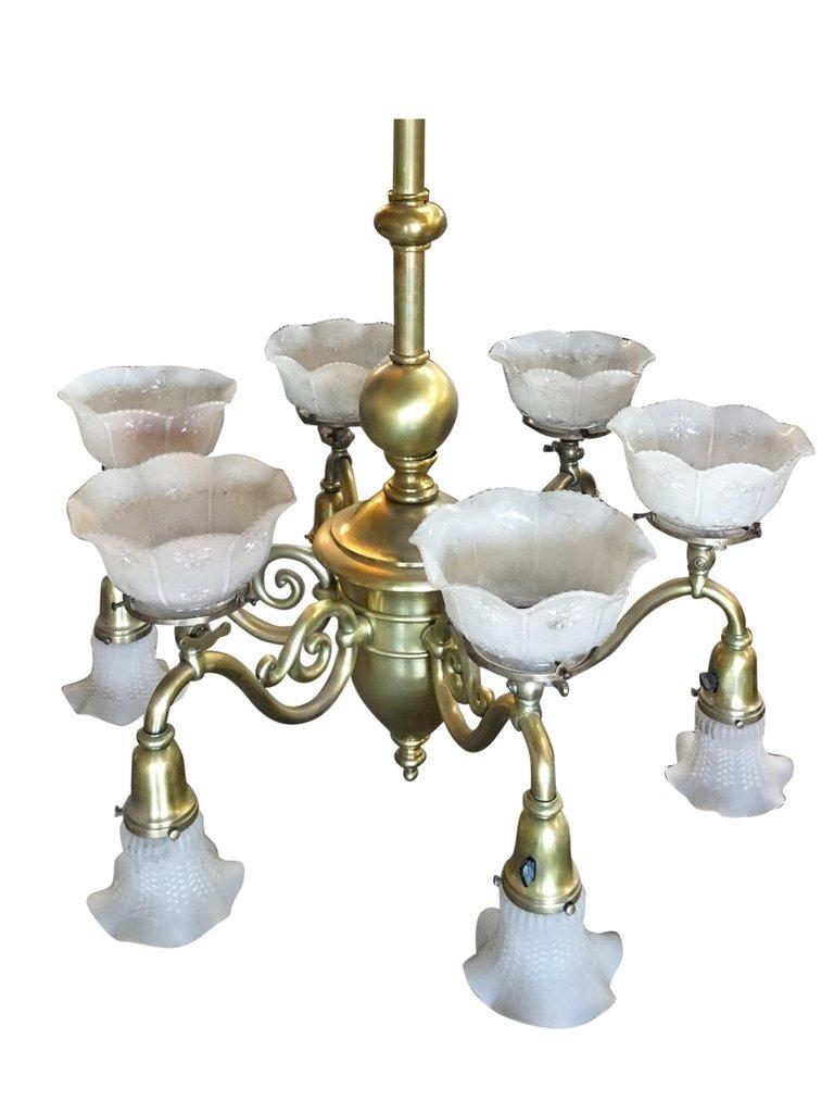 Late Victorian Cast Brass Transitional Converted Six-Arm Gas and Electric Chandelier with decorative scrolling patterns. The chandelier features 6 arms each with a top gas light and bottom electric light. 

Dimensions:
24