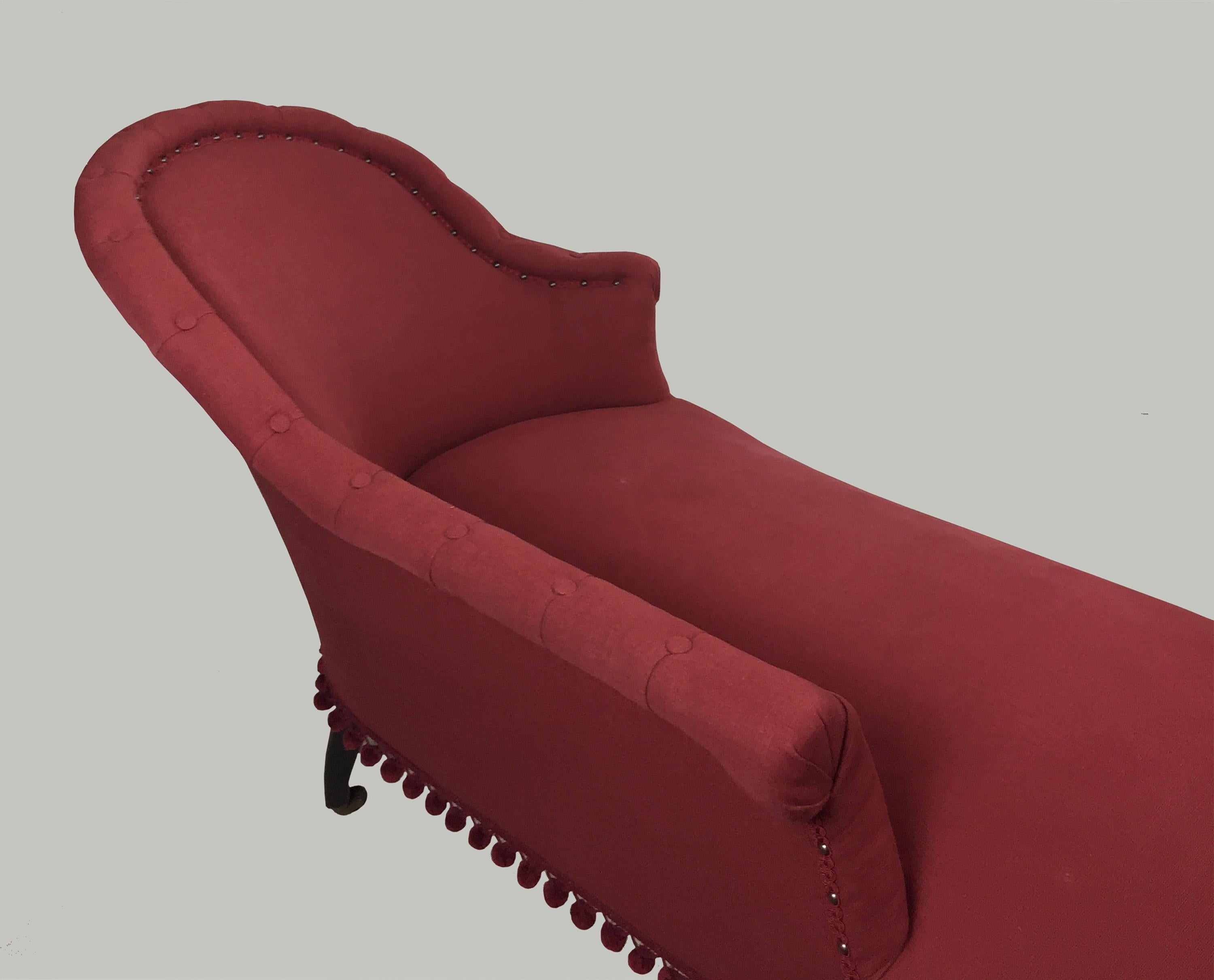 Late Victorian chaise longue in the traditional Meridienne shape, upholstered in dark prink fabric. Upholstered in the 1980s with bobble fringing.