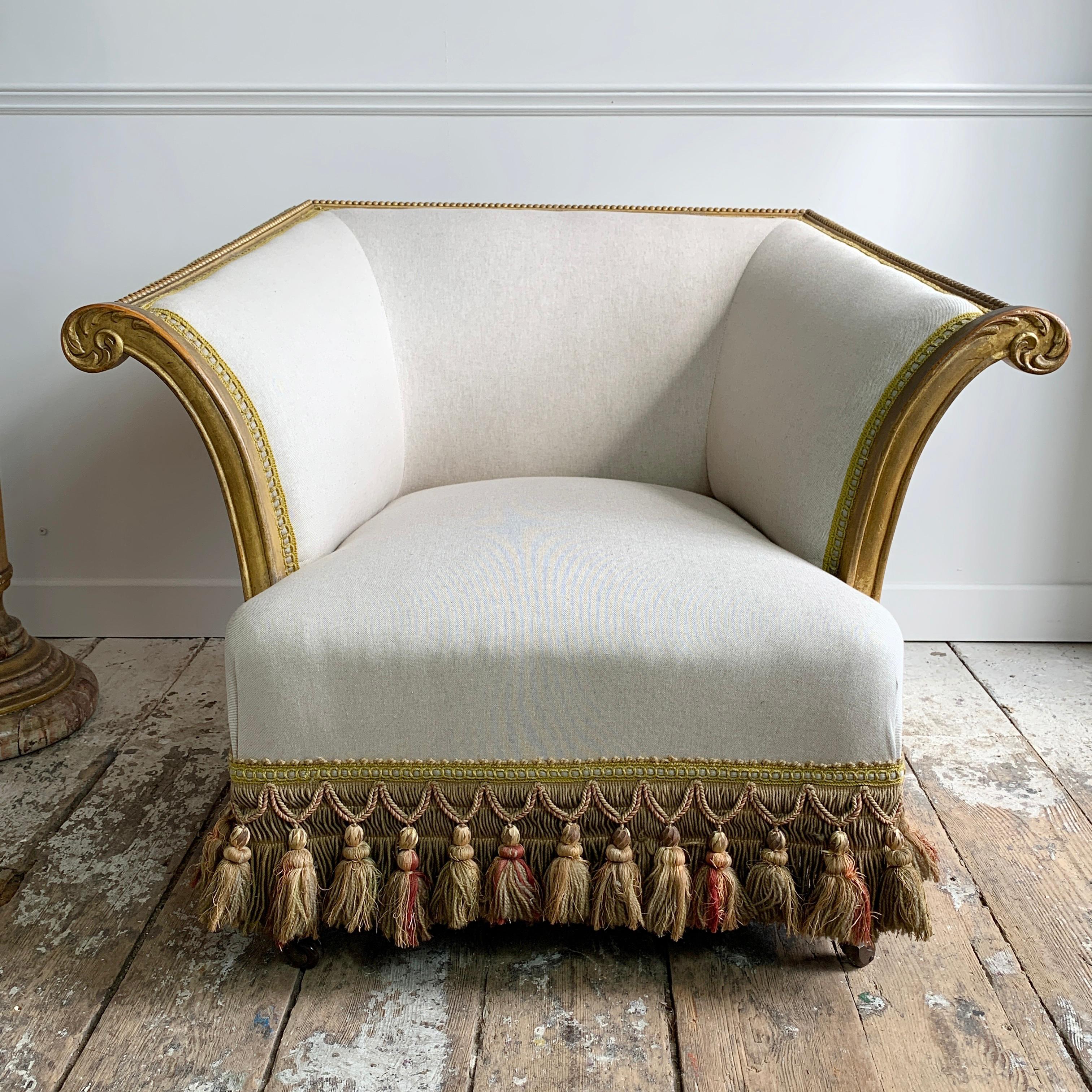 Late Victorian country house armchair, of incredible design in a swooping style that we have not encountered before
solid carved and gilt frame, recently re-upholstered to the highest standard in linen, and retaining it’s original heavy antique