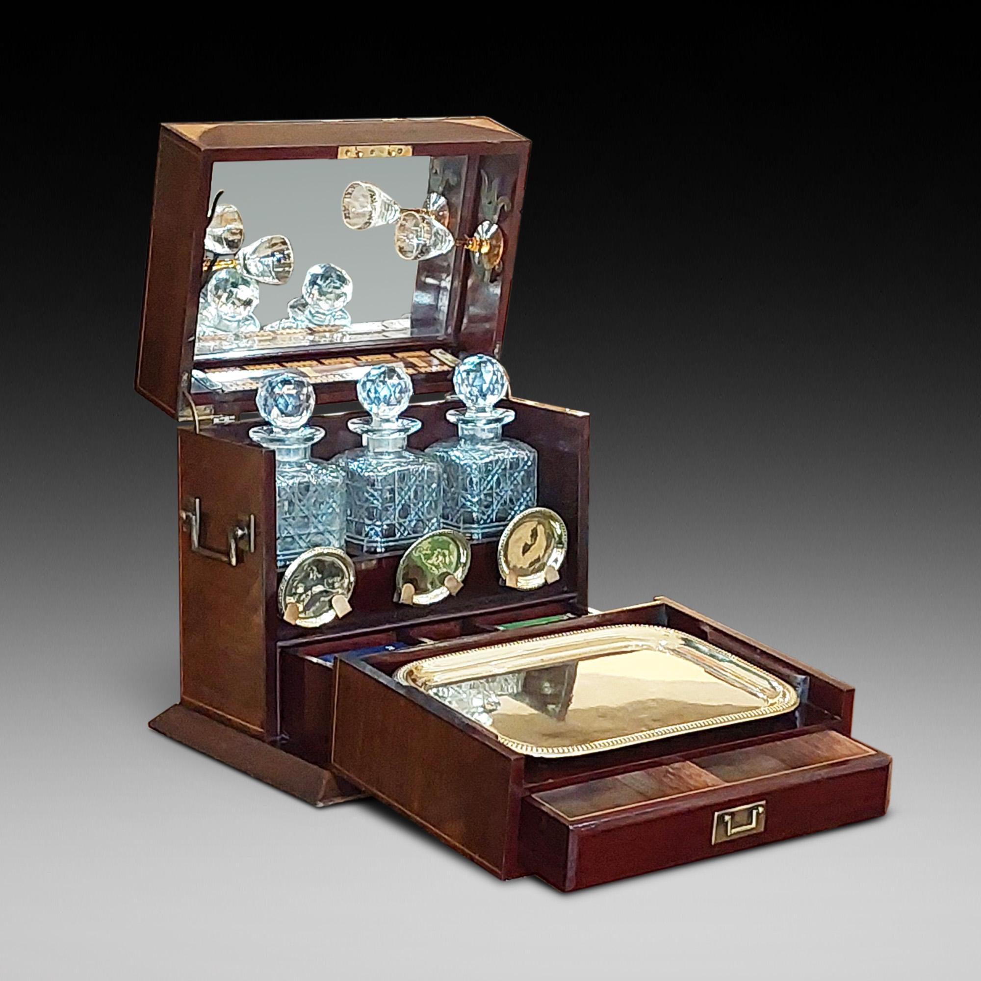 Late Victorian Decanter Box & Games Compendium - the tantalus has three cut crystal liquor bottles with a brass tray and coasters - the games compartment a fitted cribbage scorer - All in a Mahogany casket with brass handles and shell inlaid