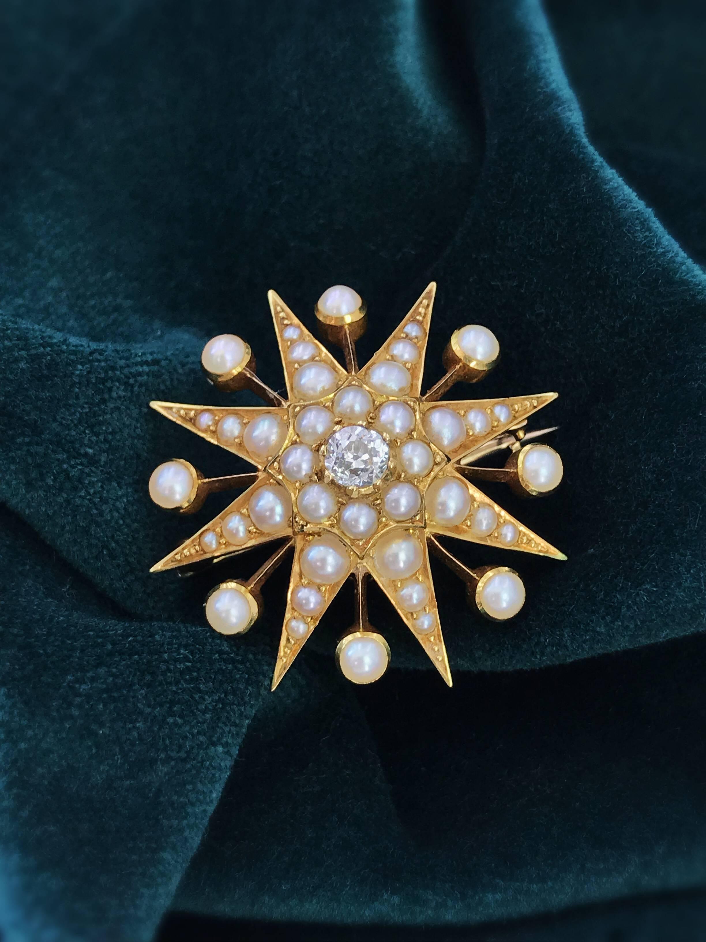 A late Victorian 15ct gold diamond and split pearl star brooch. The old-cut diamond and split pearl cluster, with graduated split pearl ray surround. May be worn as a pendant. Estimated diamond weight 0.25ct, H-I colour, SI clarity. Diameter 3.1cms.