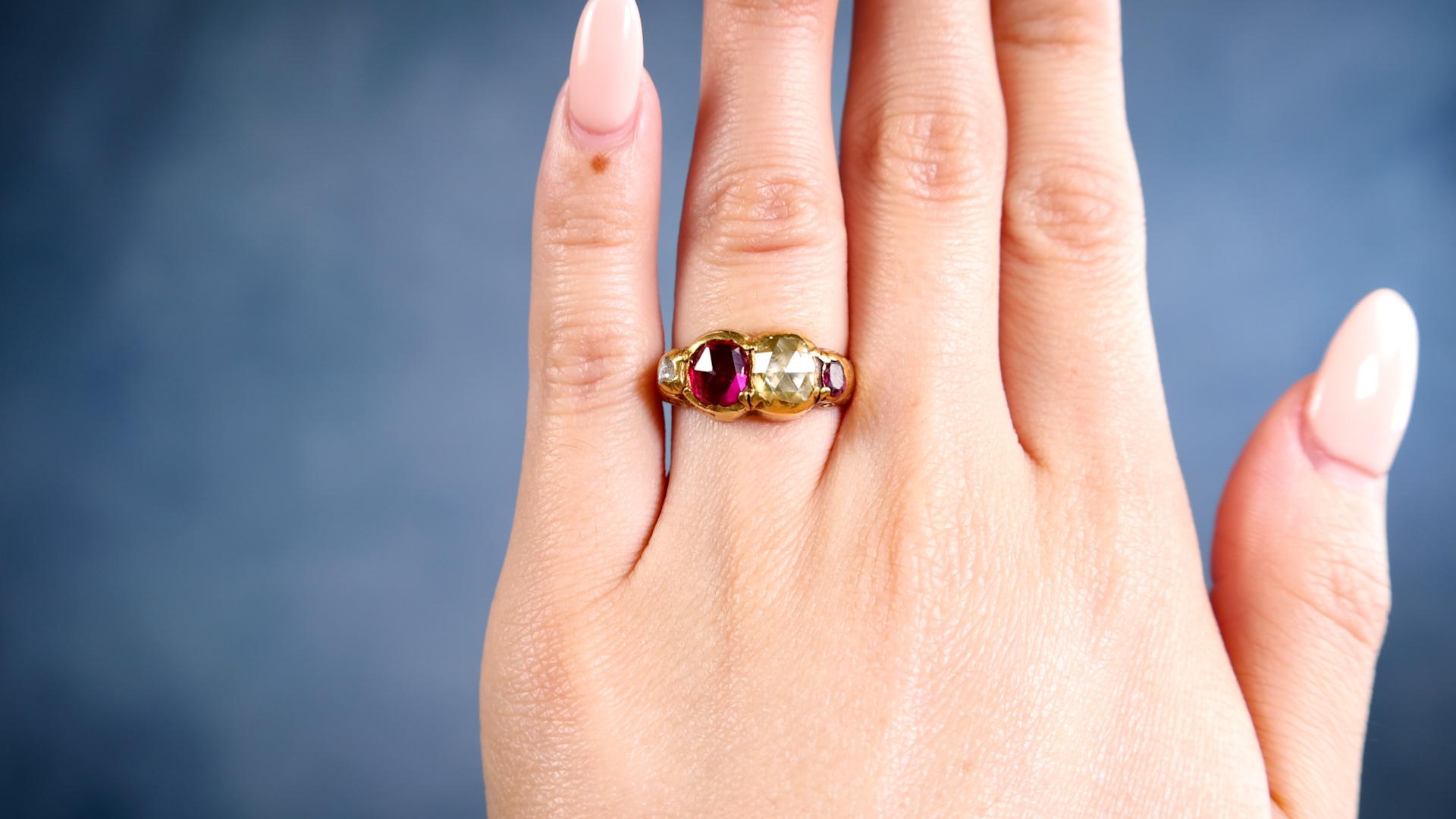 One Late Victorian Diamond and Synthetic Ruby 14k Yellow Gold Ring. Featuring one rose cut diamond weighing approximately 0.50 carat, graded S-T color, I1 clarity, and one rose cut synthetic ruby weighing approximately 0.90 carat. Accented by one
