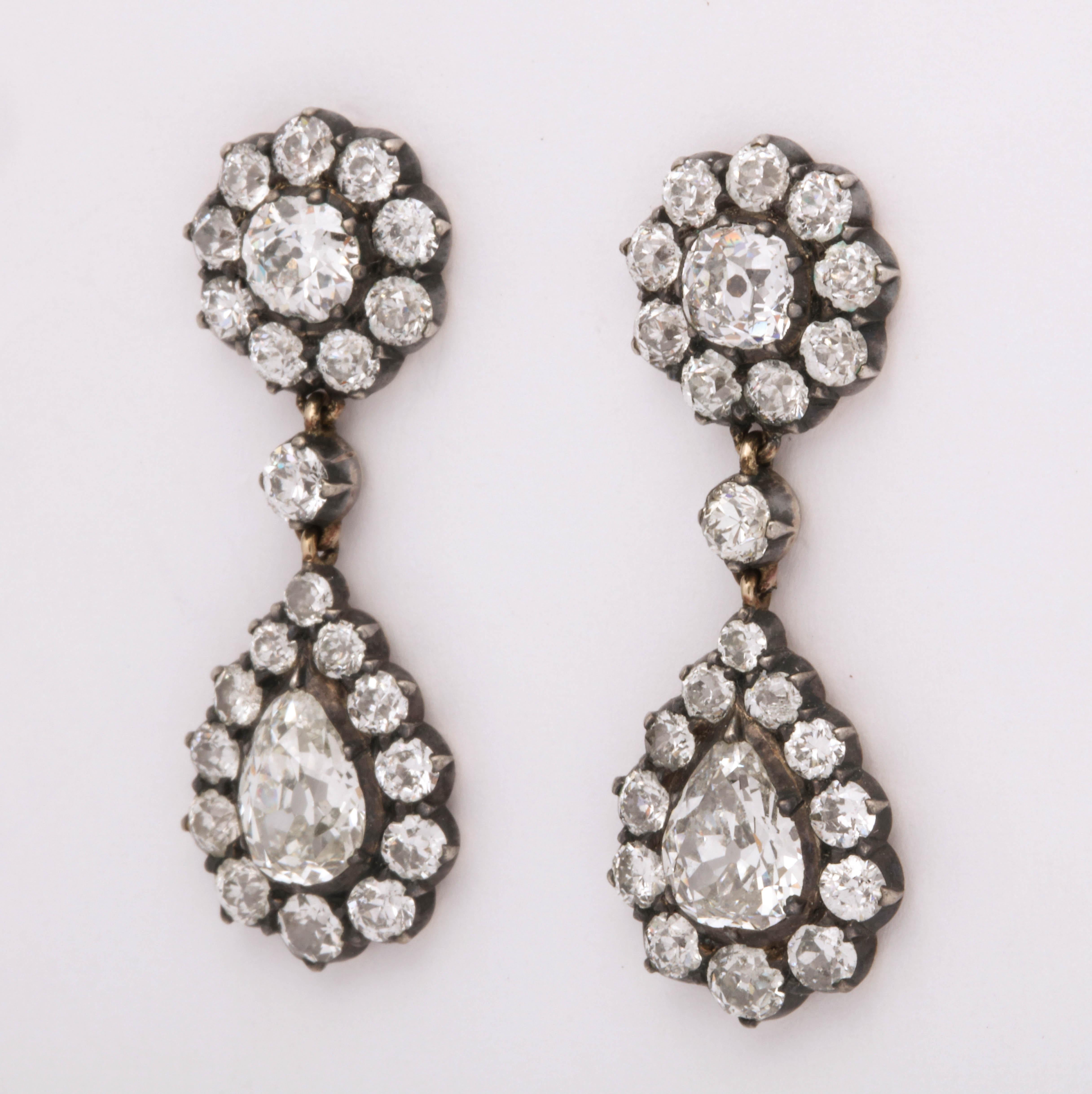 Set in silver over 15K yellow gold, these diamond earrings are set with 5.2 carats. Made in England c. 1890 and in beautiful condition. The old cut stones really sparkle! 