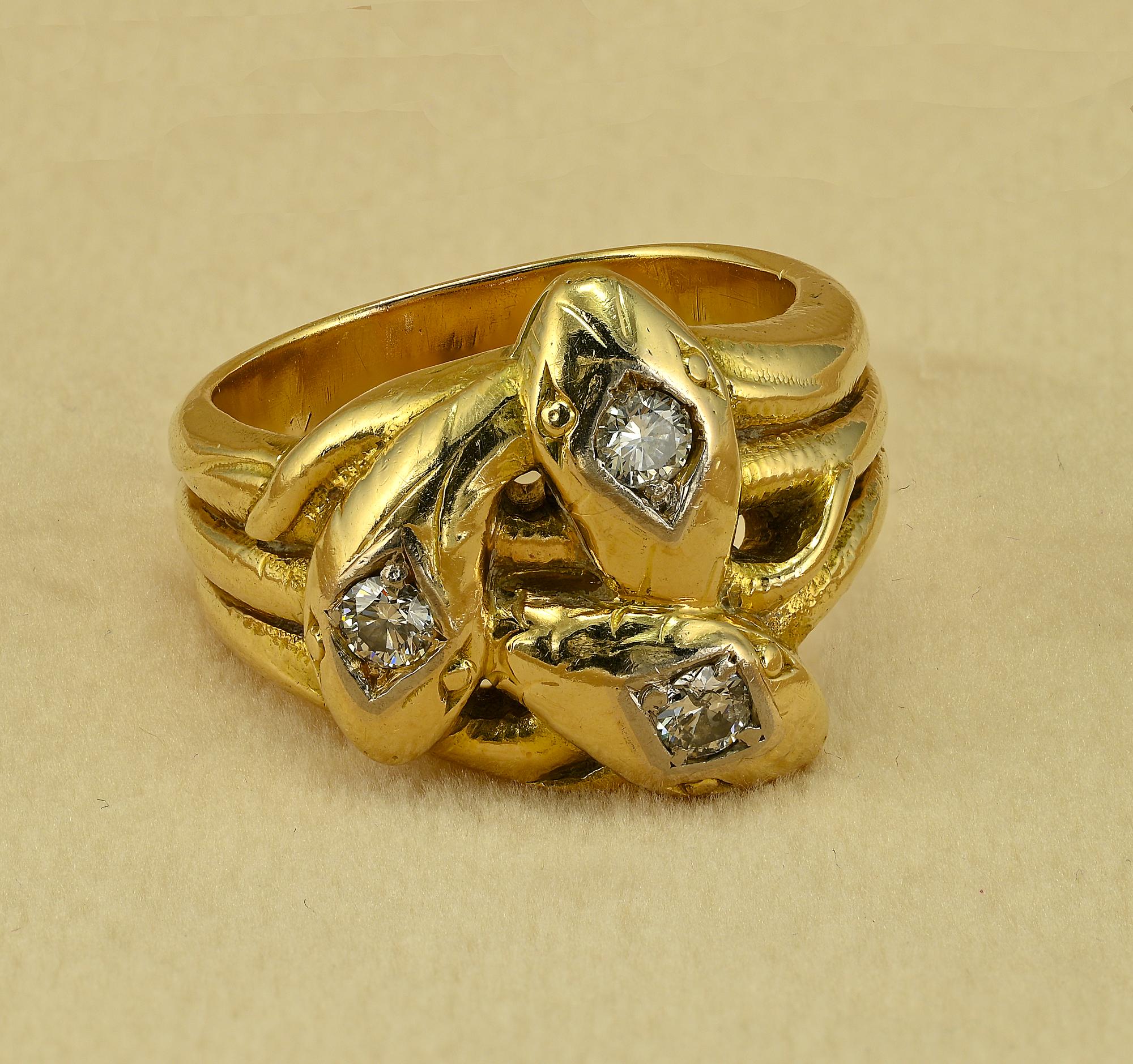 This superb antique snake ring is 1915 circa
Hand crafted of solid 14 Kt gold internally stamped with European 585 standing for 14 KT
Marvelous design with triple interlaced snake heads Diamond set
Approx .45 Ct of total Diamond content assessed G/H