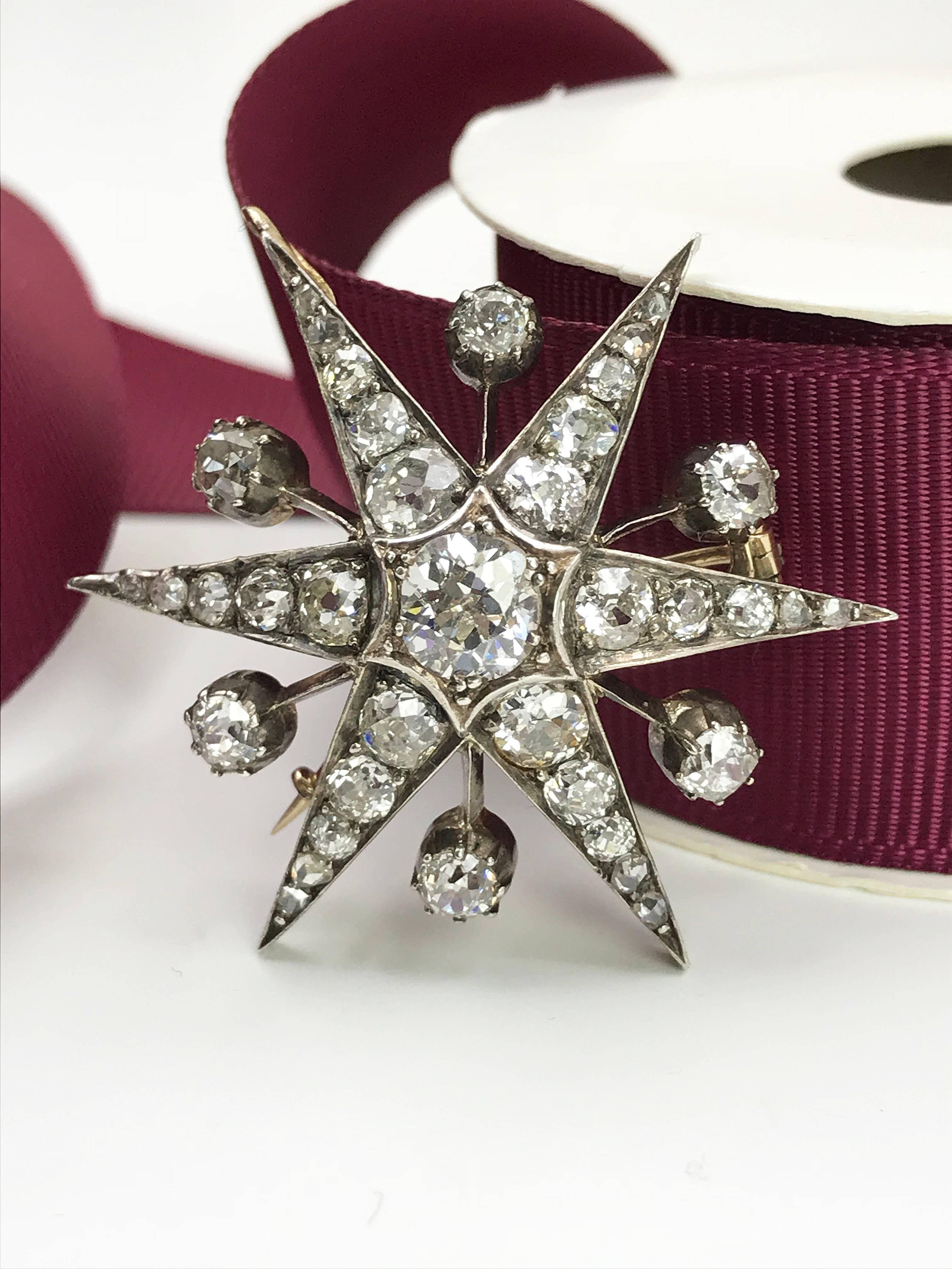 A late Victorian diamond star brooch. One of the favorite brooch style from Queen Elizabeth II. Set with 9ct gold front and silver back, old-cut diamond with vari-cut diamond rays and spacers. May be worn as a pendant. Estimated total diamond weight