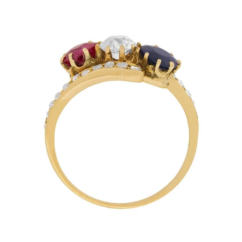 This wonderfully unique three stone twist ring is unlike any other! It has a lovely pinkish ruby to start, followed by a sparkling old cut diamond, and finished with a lovely blue sapphire. All three stones have the same weight, 0.40 carat and are