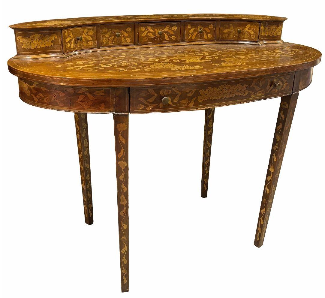 Late 19th century Dutch Marquetry Writing Desk with 6 drawers. Intricately crafted with traditional marquetry techniques it is adorned with stunning inlay patterns of different colored woods and detailing shading.

Dimensions: Height: 32