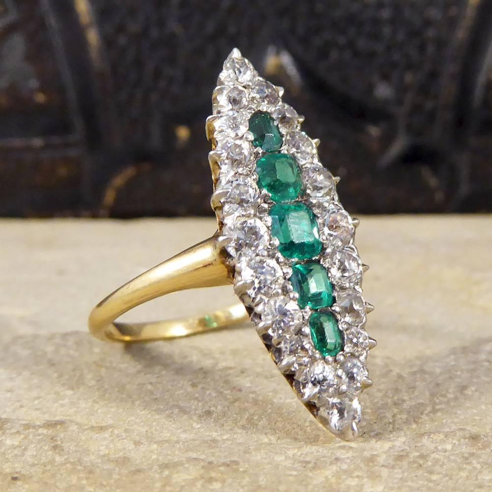 This delightful Late Victorian ring has been made with such care showing how quality pieces stand the test of time. With five Emeralds weighing a total of 0.72ct down the centre and 1.25ct of Old Cut Diamonds creating a marquise shape, this ring has