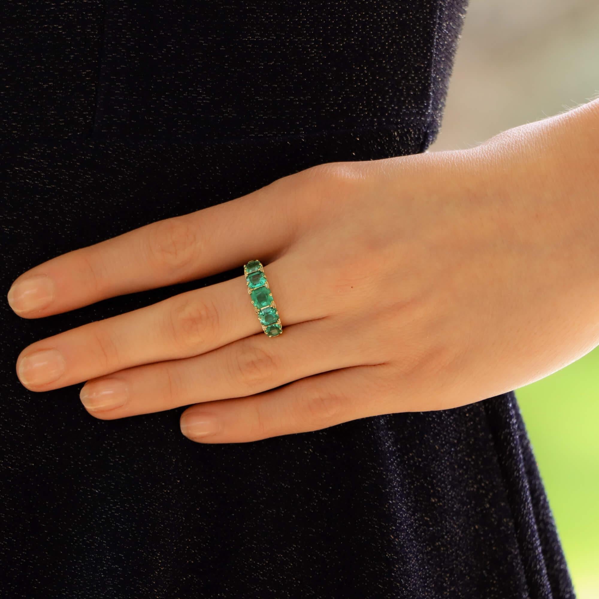 A beautiful Victorian emerald and diamond five stone ring set in 18k yellow gold. 

The ring is set with five vibrant square cut emeralds, all of which are perfectly matched in colour. These emeralds evenly graduate in size as they travel across the