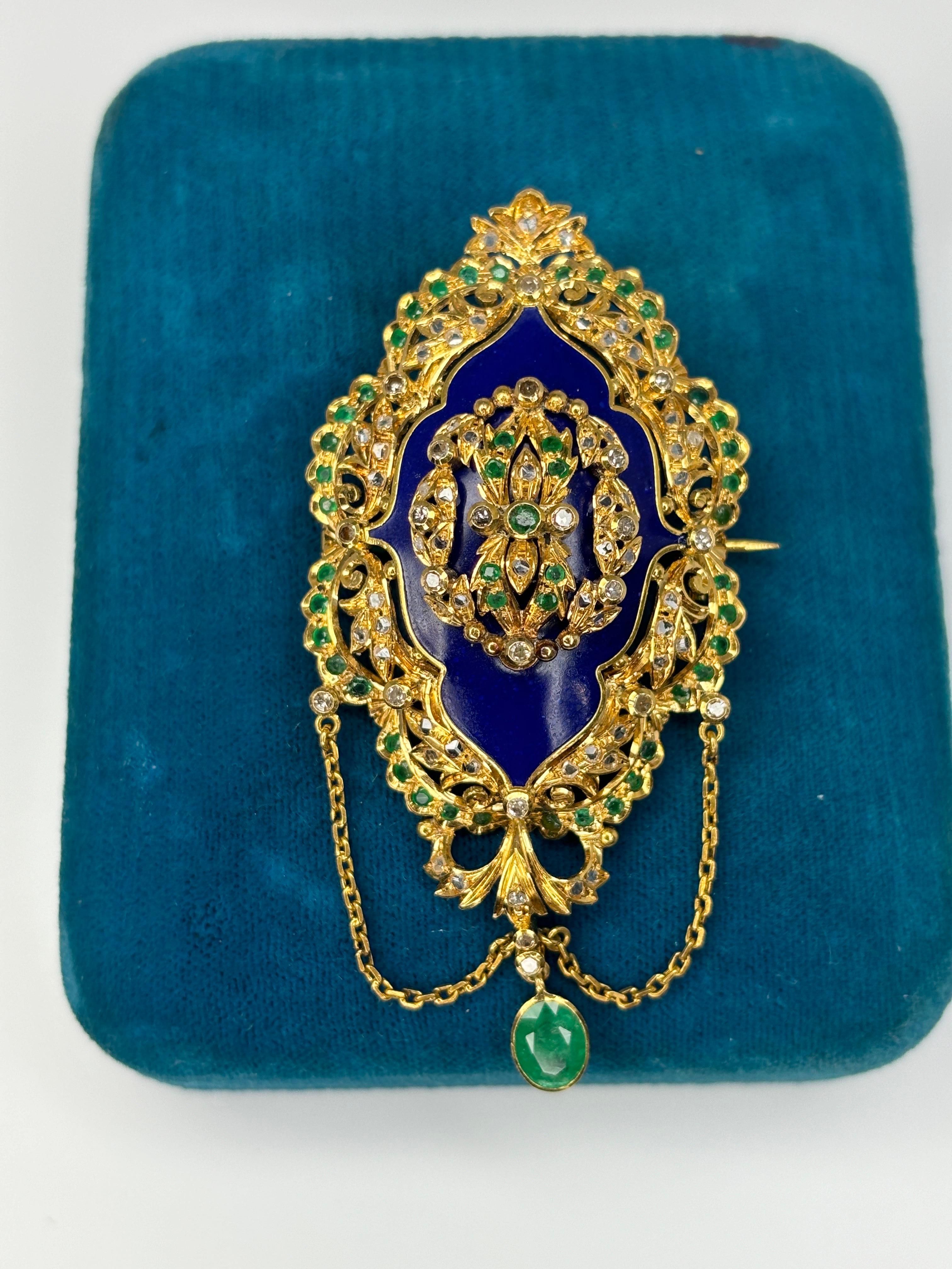 This beautiful and well preserved antique brooch dates back to circa 1890's. It features emeralds & diamonds and is decorated with blue enameling. The enameling on this piece is intact which signifies that this brooch has been a cherished piece of