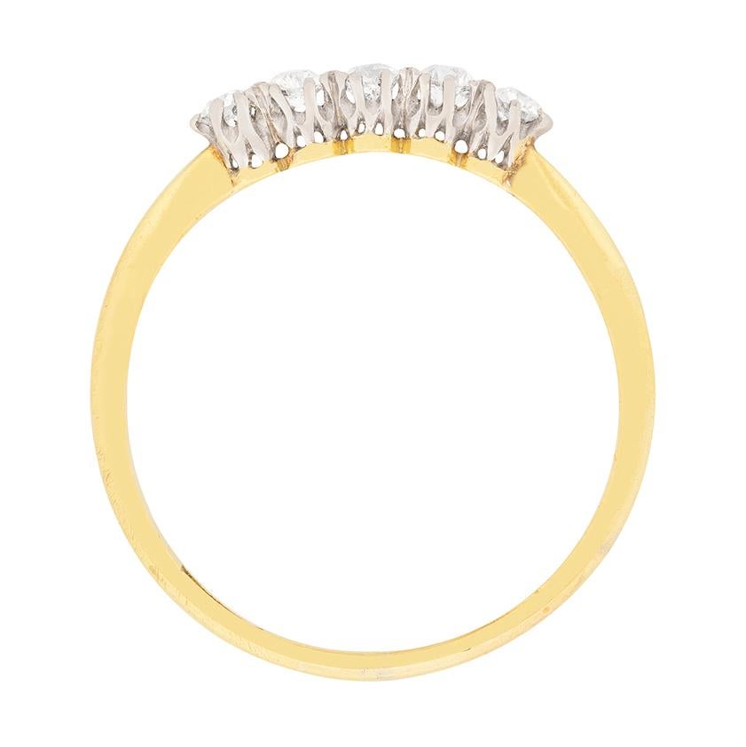 Five old cut diamonds sparkle side by side in pierced platinum galleries atop an 18 carat yellow gold band at the heart of this late Victorian era ring. The diamonds, which are old cut stones, have a combined weight of 0.50 carat and are shining
