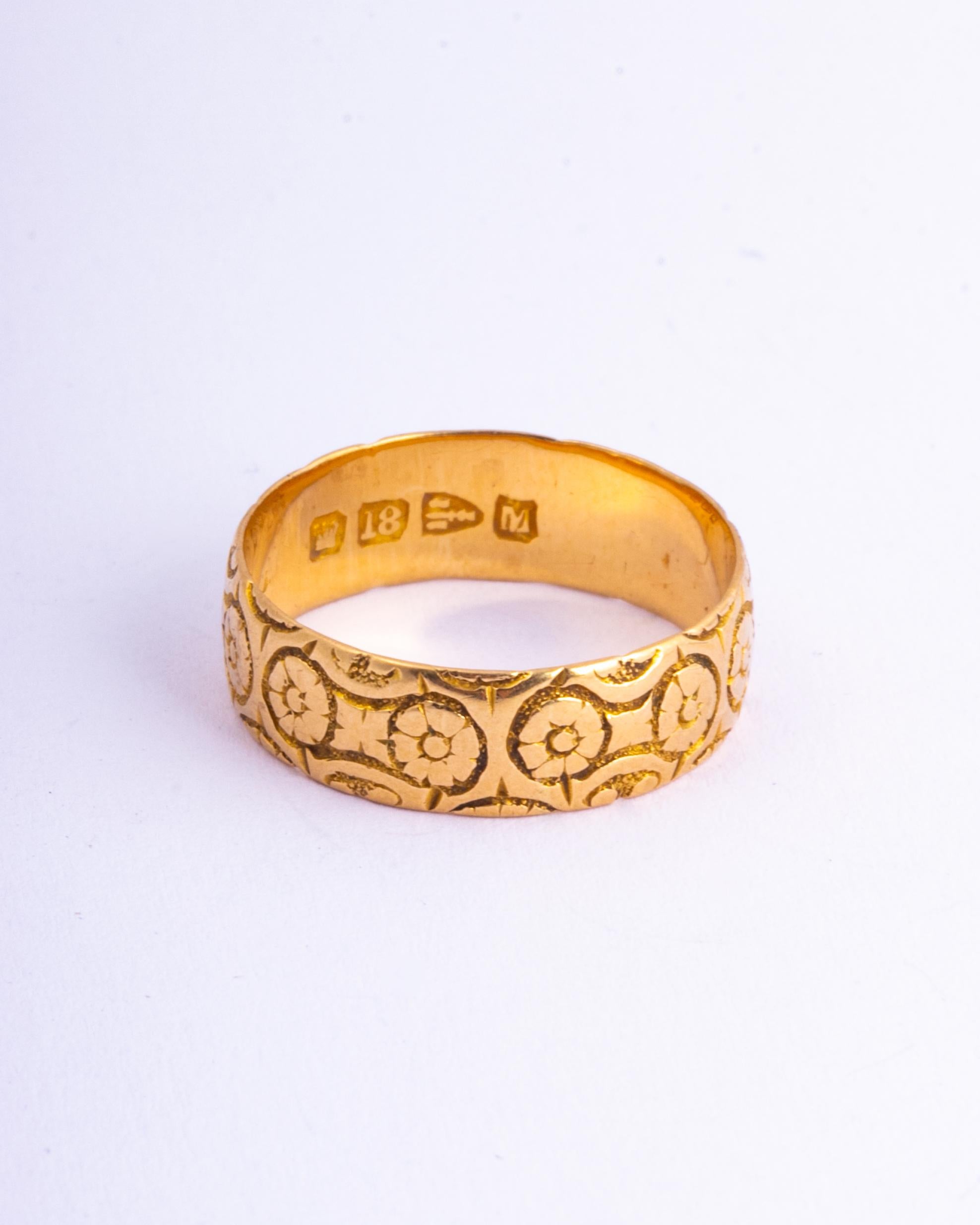 This beautifully decorative 18ct gold band features stunning floral style engraving. Made in Chester, England. 

Ring Size: N 1/4 or 7
Band Width: 6mm

Weight: 3.55g