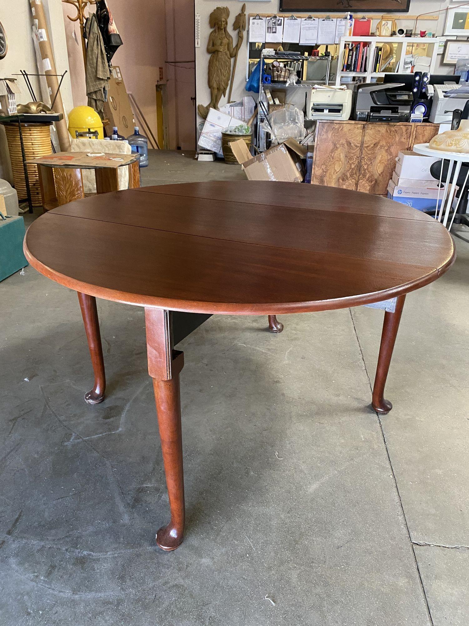 Mesa de comedor francesa de principios del siglo XX, de madera maciza de roble. La parte superior se asienta sobre un sencillo delantal sostenido por cuatro maravillosas patas torneadas. Cada hoja desplegable tiene un soporte de madera que se extrae