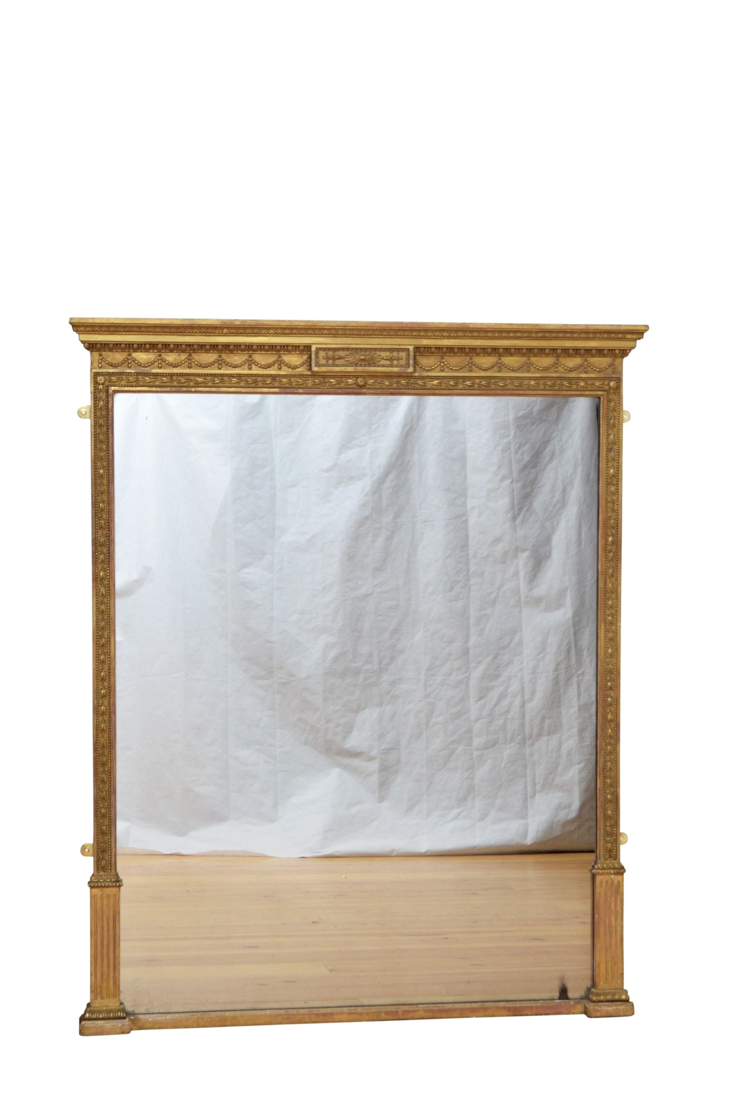 Fine Victorian gilded overmantel mirror, having original glass with some imperfections in floral carved frame with moulded cornice above egg and dart decoration and swags to the frieze. This antique wall mirror retains its original gilt, glass and