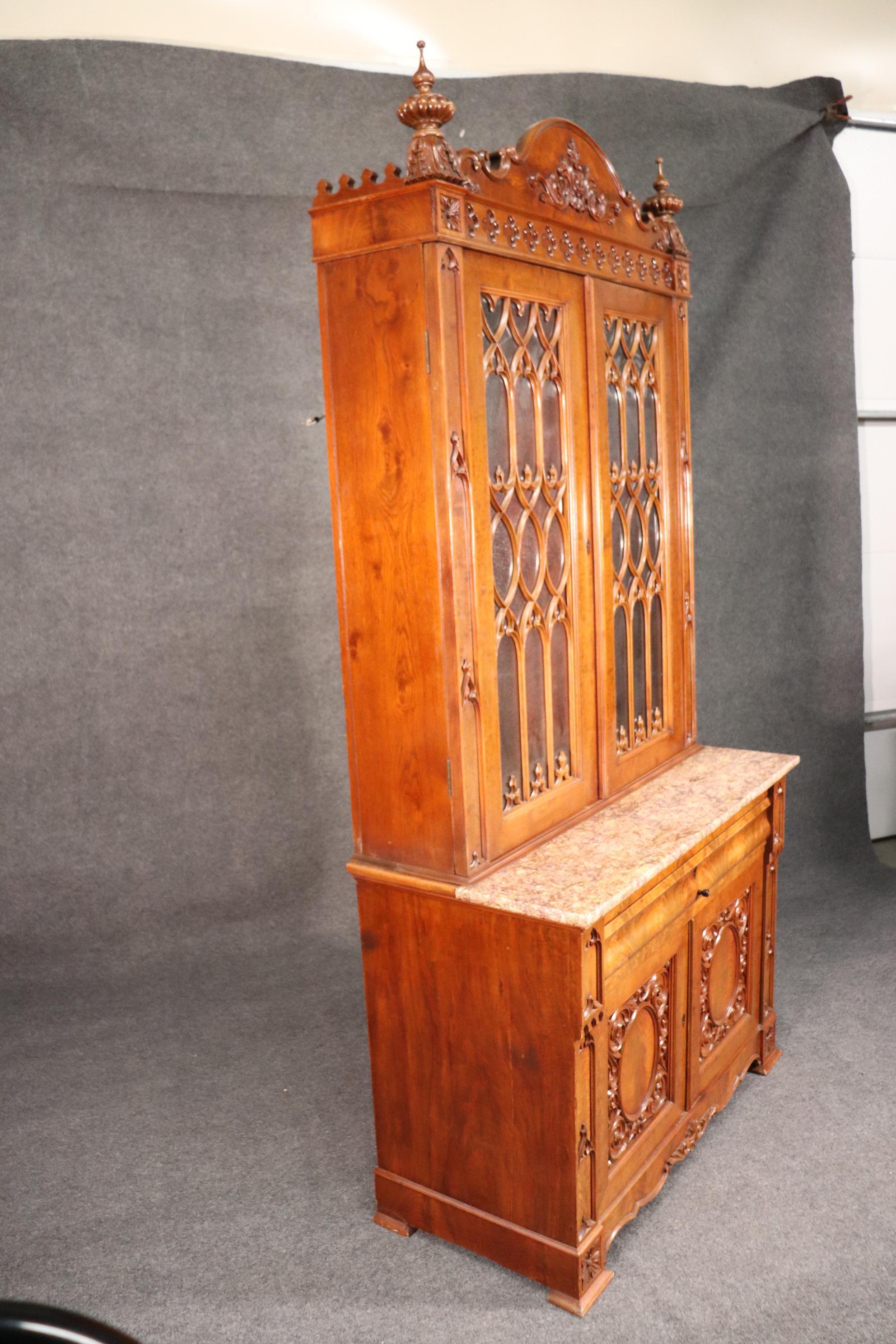 This is a very unique form of late Victorian secretary desk. Possibly made in New Orleans, because of its French marble and gothic styled tracery doors, this piece is in good condition and looks as if it was restored at some point. The piece