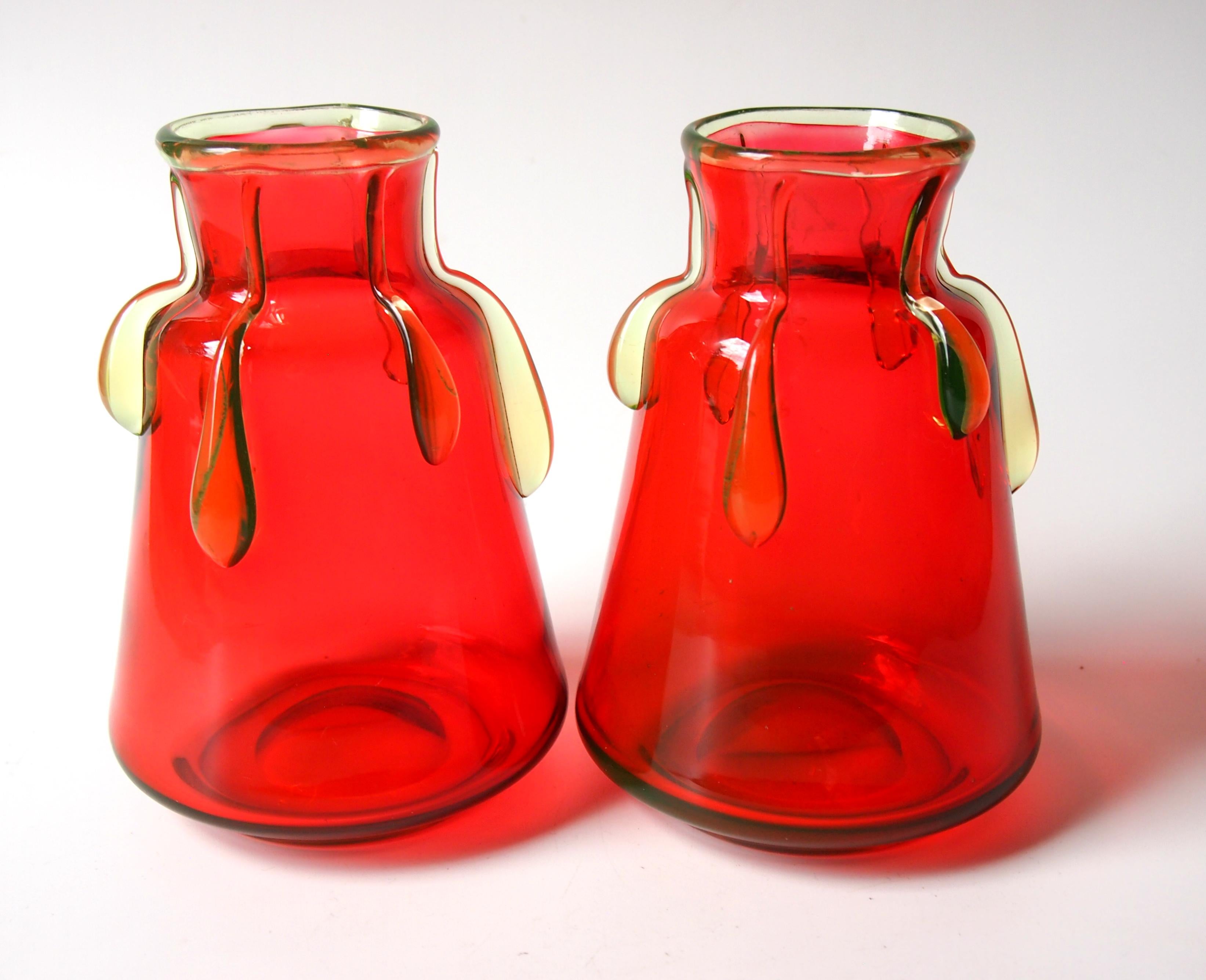 Super pair of Harrach orange-red vases with hot applied uranium glass drips in the late Victorian style.

Harrach has been the backbone of Bohemian, and possibly European, glass for the last 300 years. It proudly celebrates its tri-centenary in