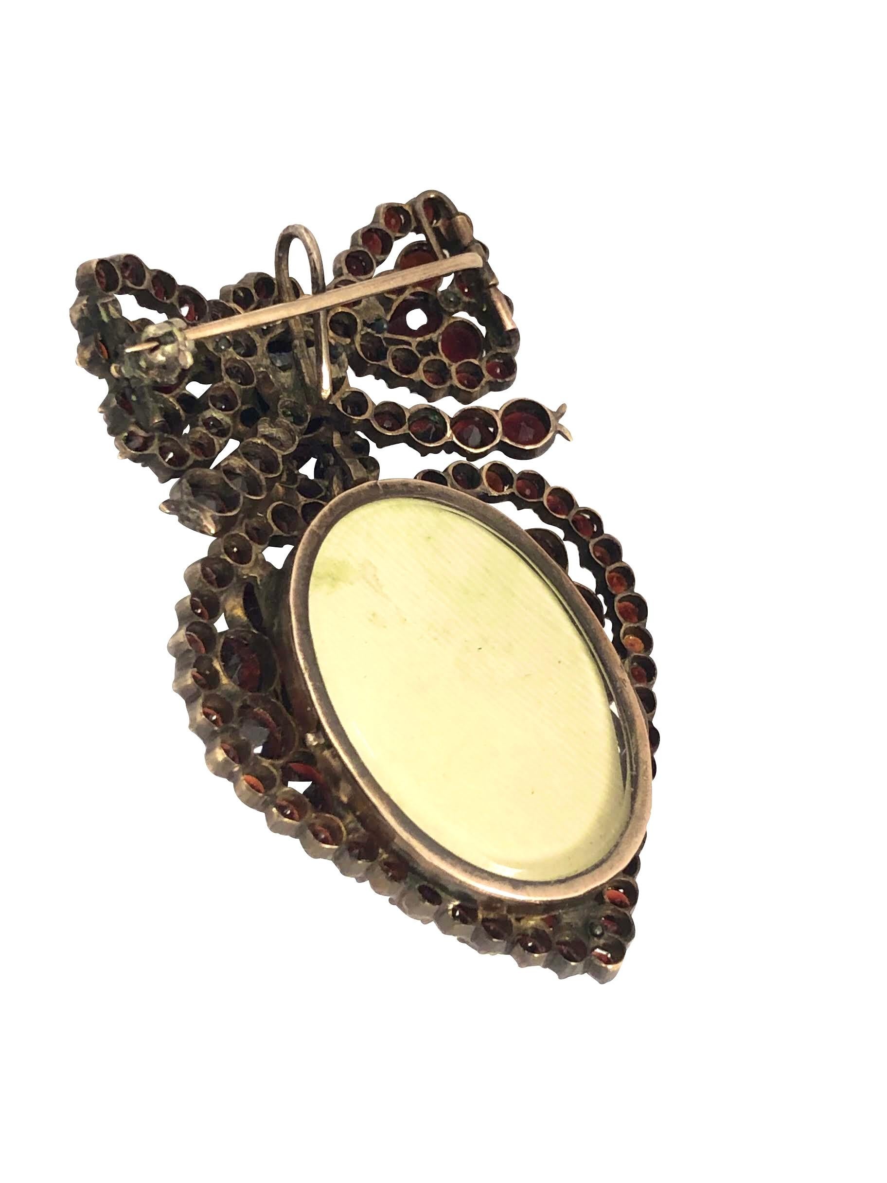Pear Cut Late Victorian Large Garnet Heart Locket Bow Brooch Pendant For Sale